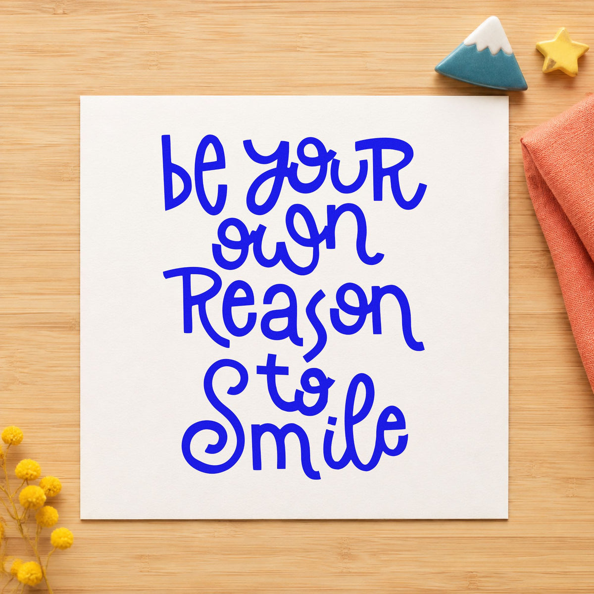 Be Your Own Reason Smile craft stamp imprinted in blue ink on paper, a design suited to framed vanity corner.