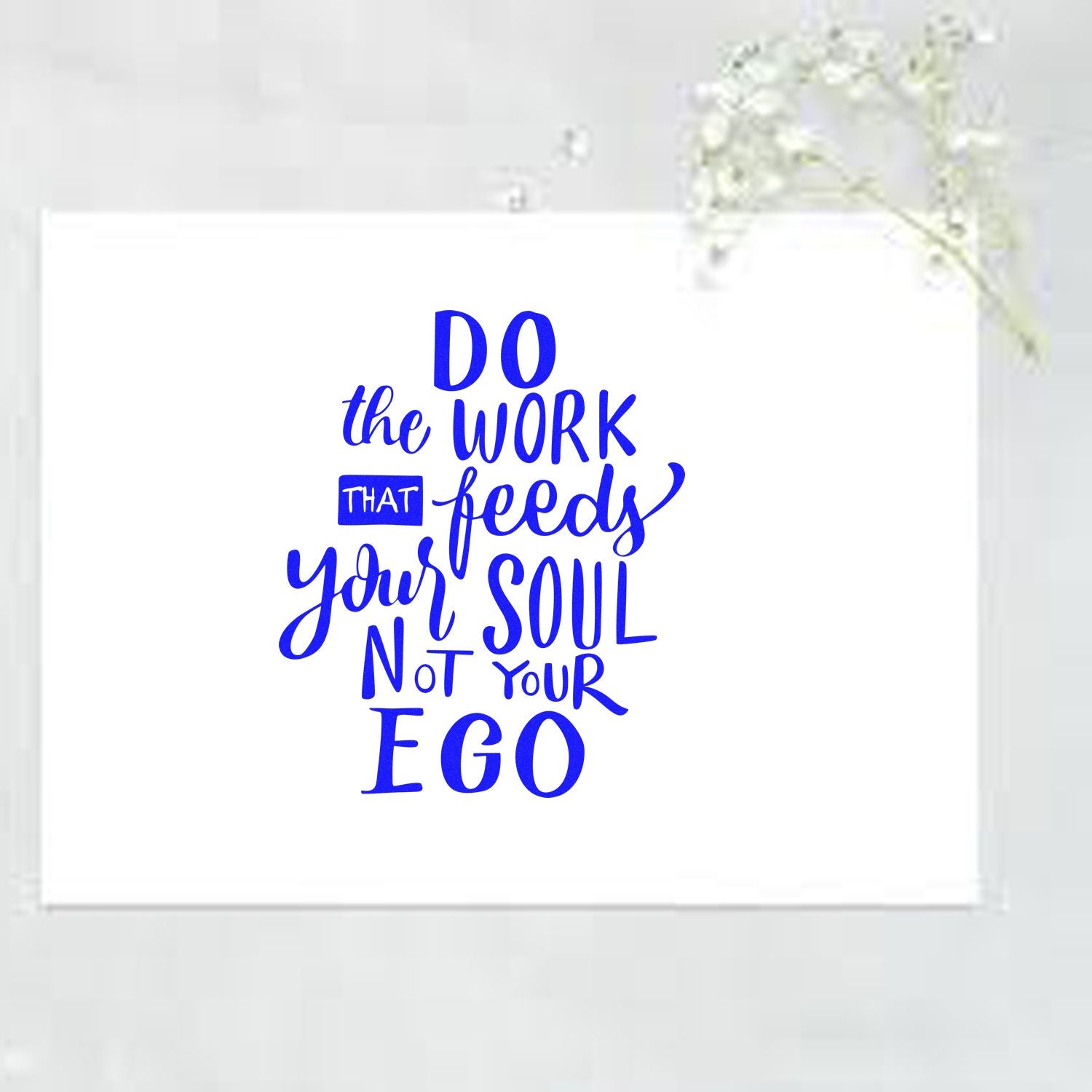 Inspirational rubber stamp with quote, Do the work that feeds your soul, not your ego, in bold blue lettering.