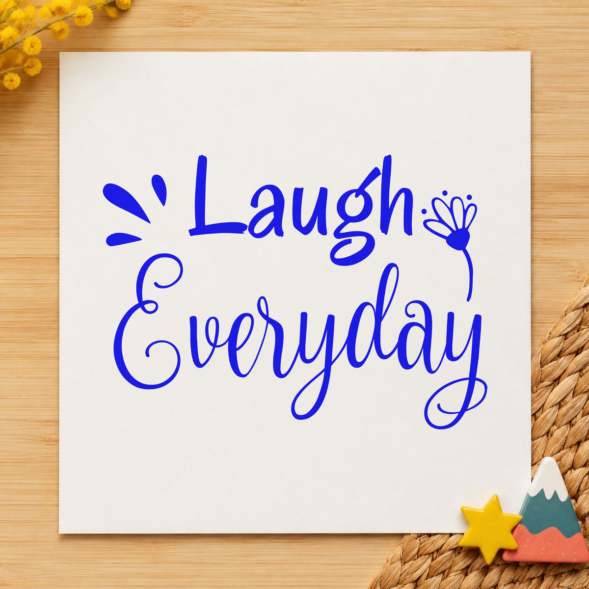 Laugh Every Day Flower craft stamp in blue ink on cardstock, an easy option for cushion cover printing.