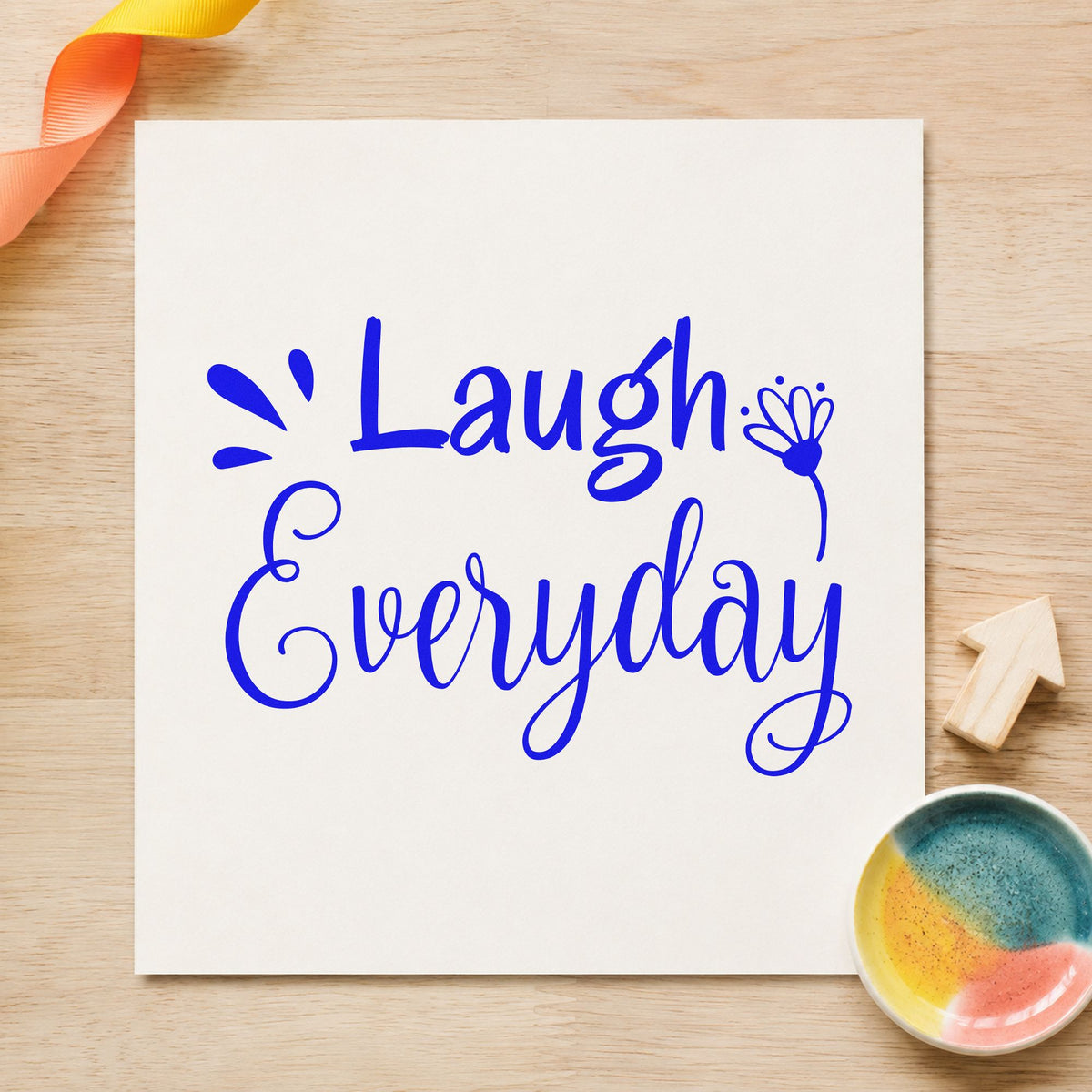 Laugh Every Day Flower craft stamp imprinted in blue ink on paper, a design suited to framed den wall.