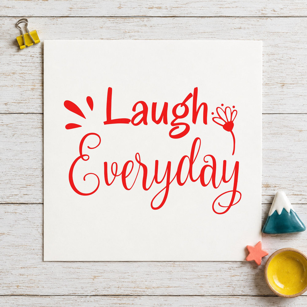 Laugh Every Day Flower rubber stamp shown in red ink, stamped for projects such as shelf game labels.