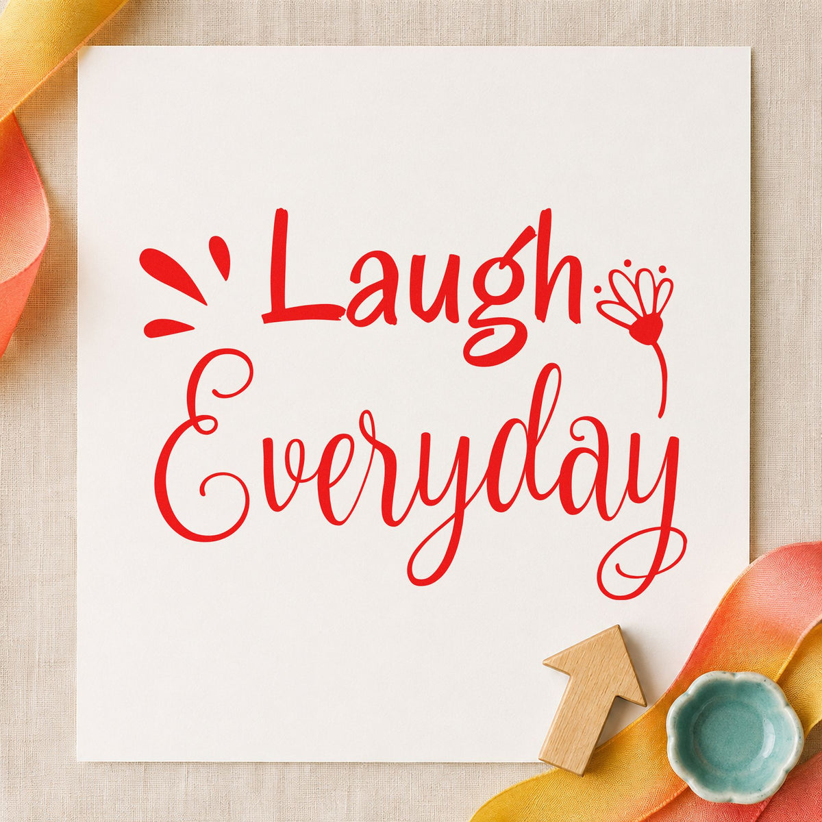 Laugh Every Day Flower craft stamp imprint in red ink on a handmade project, one idea being punchline cards.