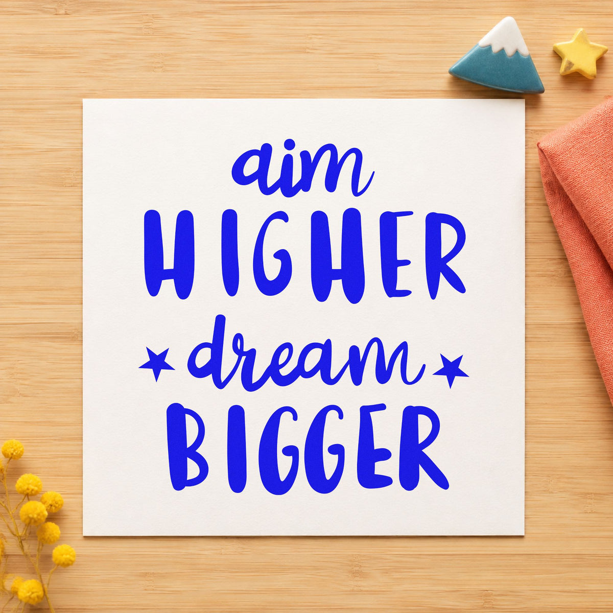 Aim Higher Dream Bigger craft stamp in blue ink on cardstock, an easy option for field banner printing.