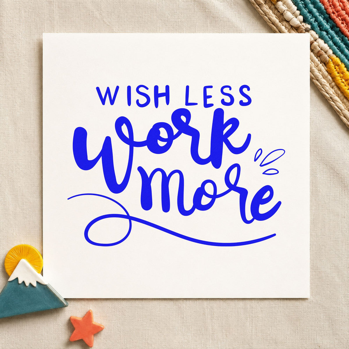 Wish Less Work More craft stamp in blue ink on cardstock, an easy option for tool roll printing.