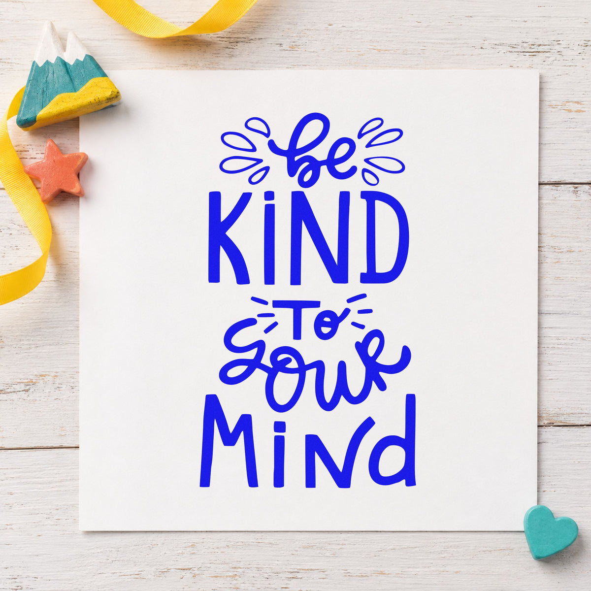 Be Kind To Your Mind craft stamp imprinted in blue ink on paper, a design suited to framed quiet corner.