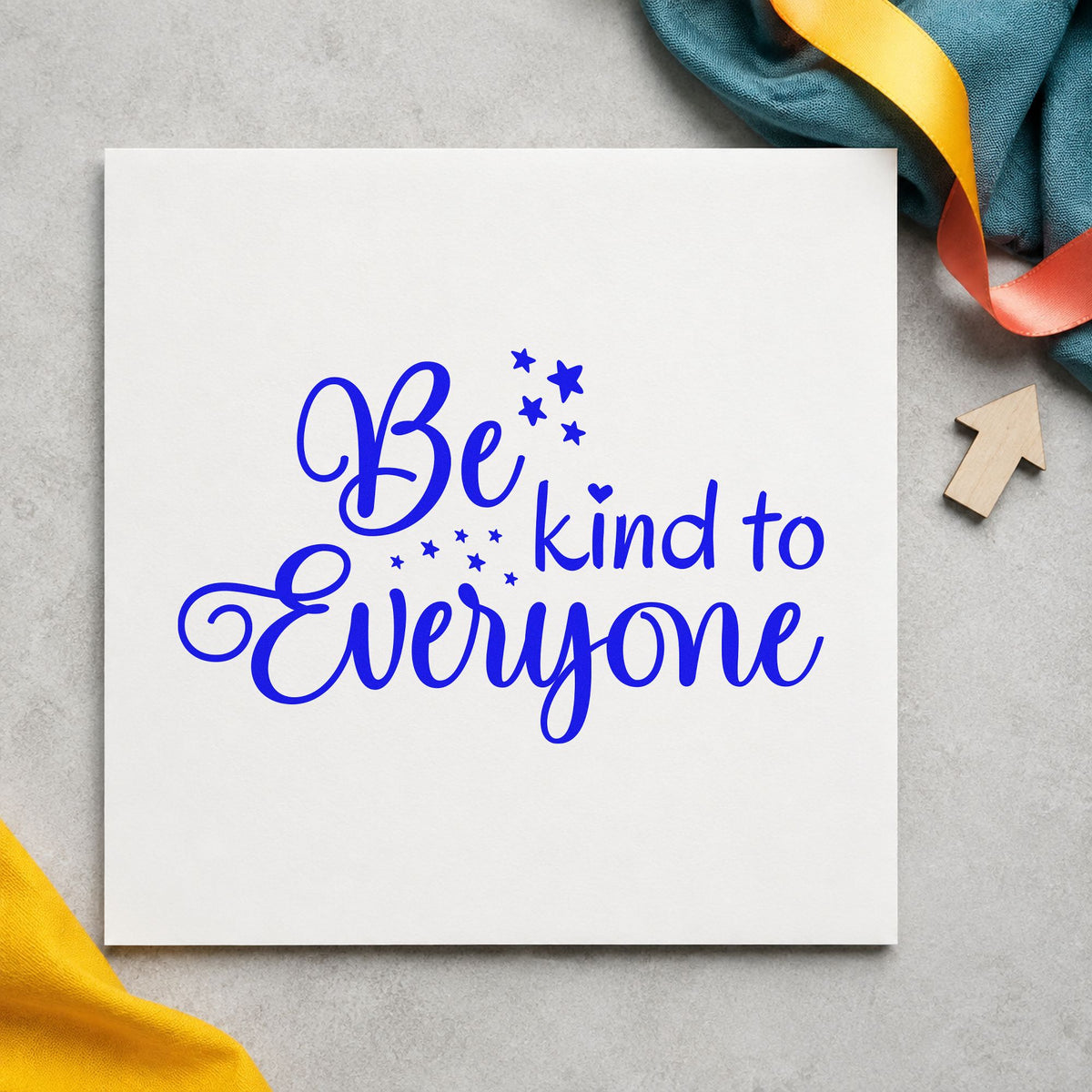 Be Kind To Everyone craft stamp in blue ink on cardstock, an easy option for class flag printing.