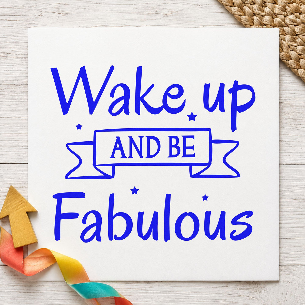 Wake Up And Be Fabulous craft stamp in blue ink on cardstock, an easy option for makeup bag printing.