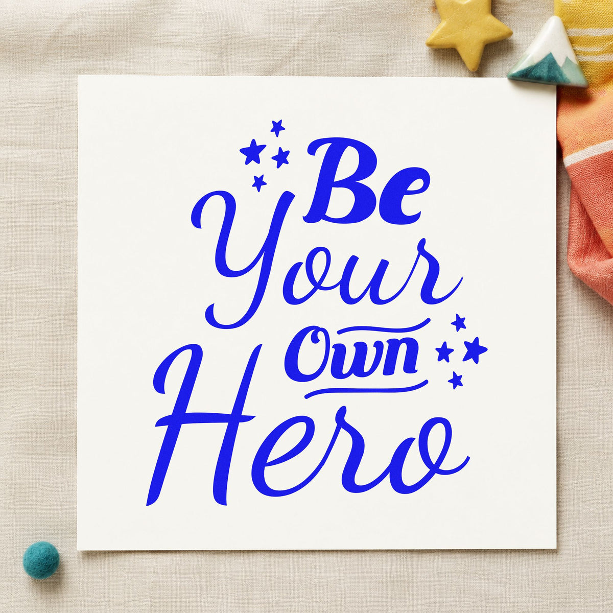 Be Your Own Hero craft stamp in blue ink on cardstock, an easy option for cape panel printing.