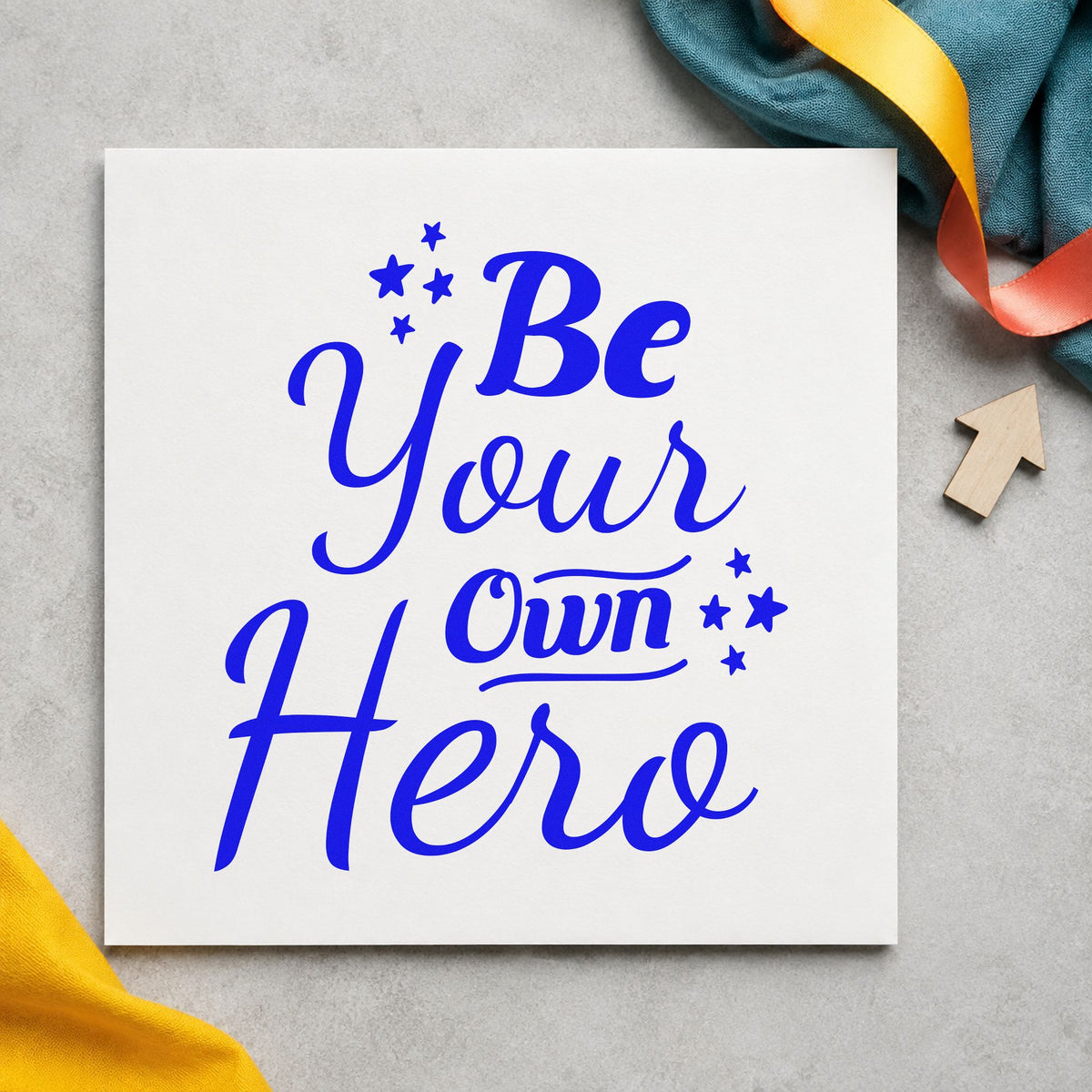 Be Your Own Hero craft stamp imprinted in blue ink on paper, a design suited to framed party entry.