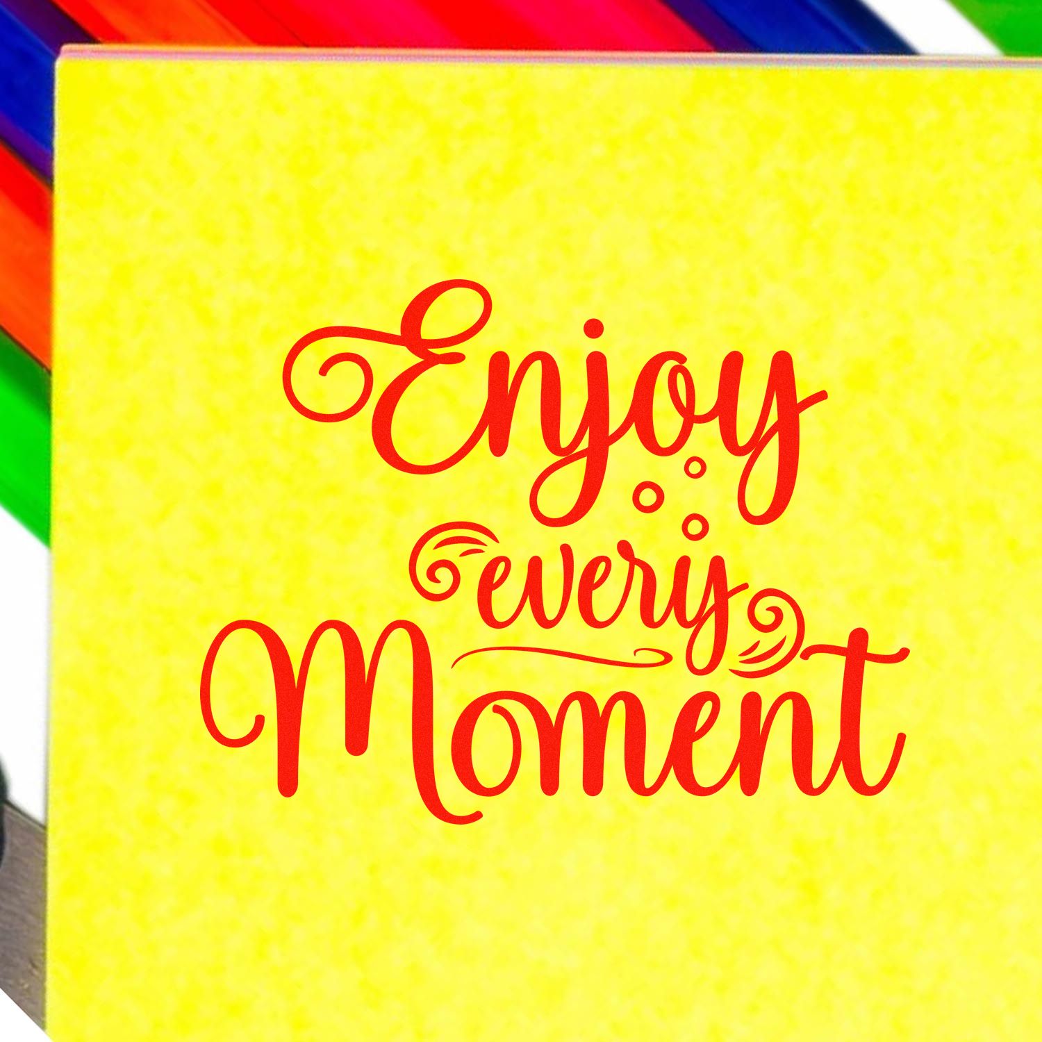 Decorative rubber stamp design with red Enjoy Every Moment script on yellow background, ideal for crafting and gift packaging.