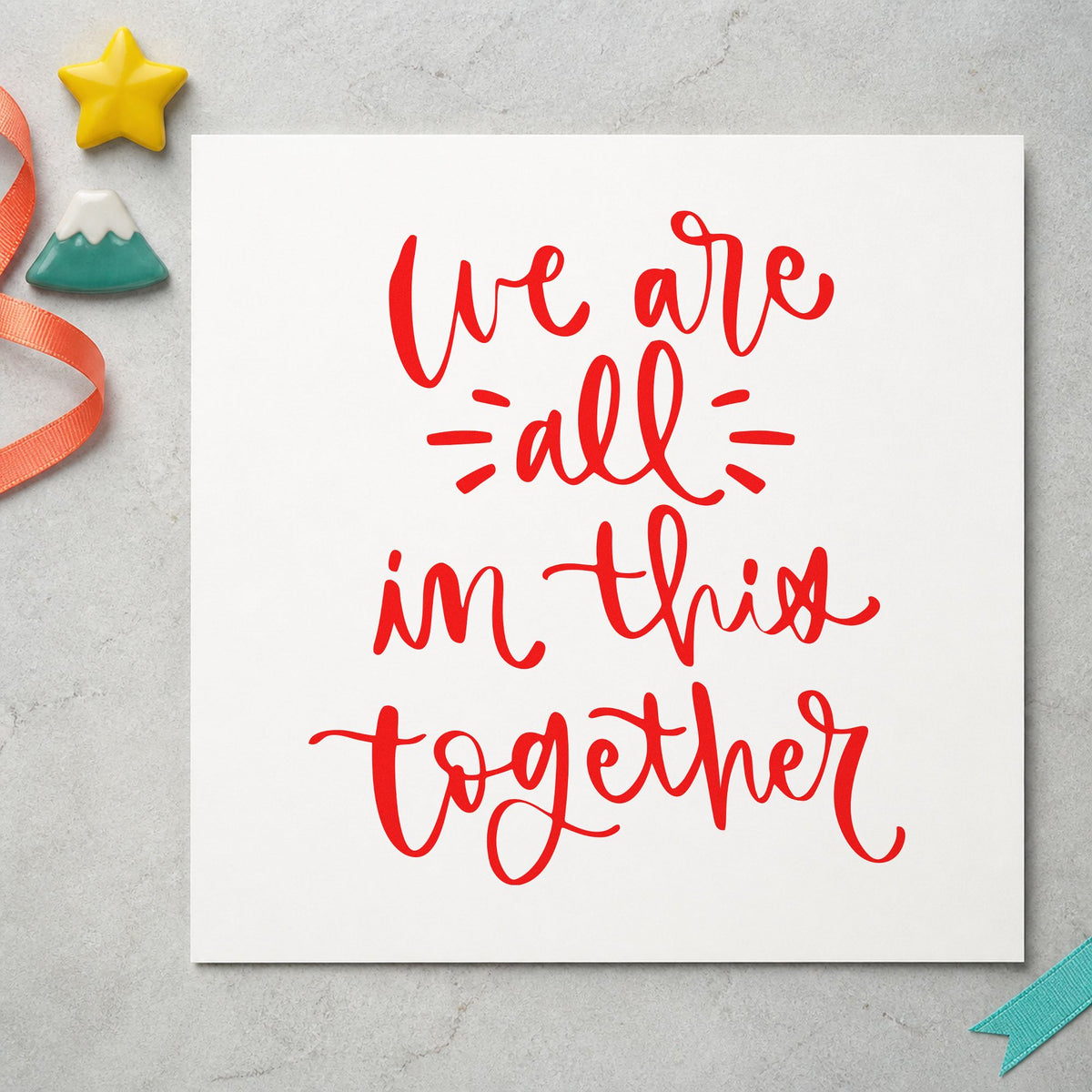 We Are All In Together craft stamp imprint in red ink on a handmade project, one idea being contact list cards.