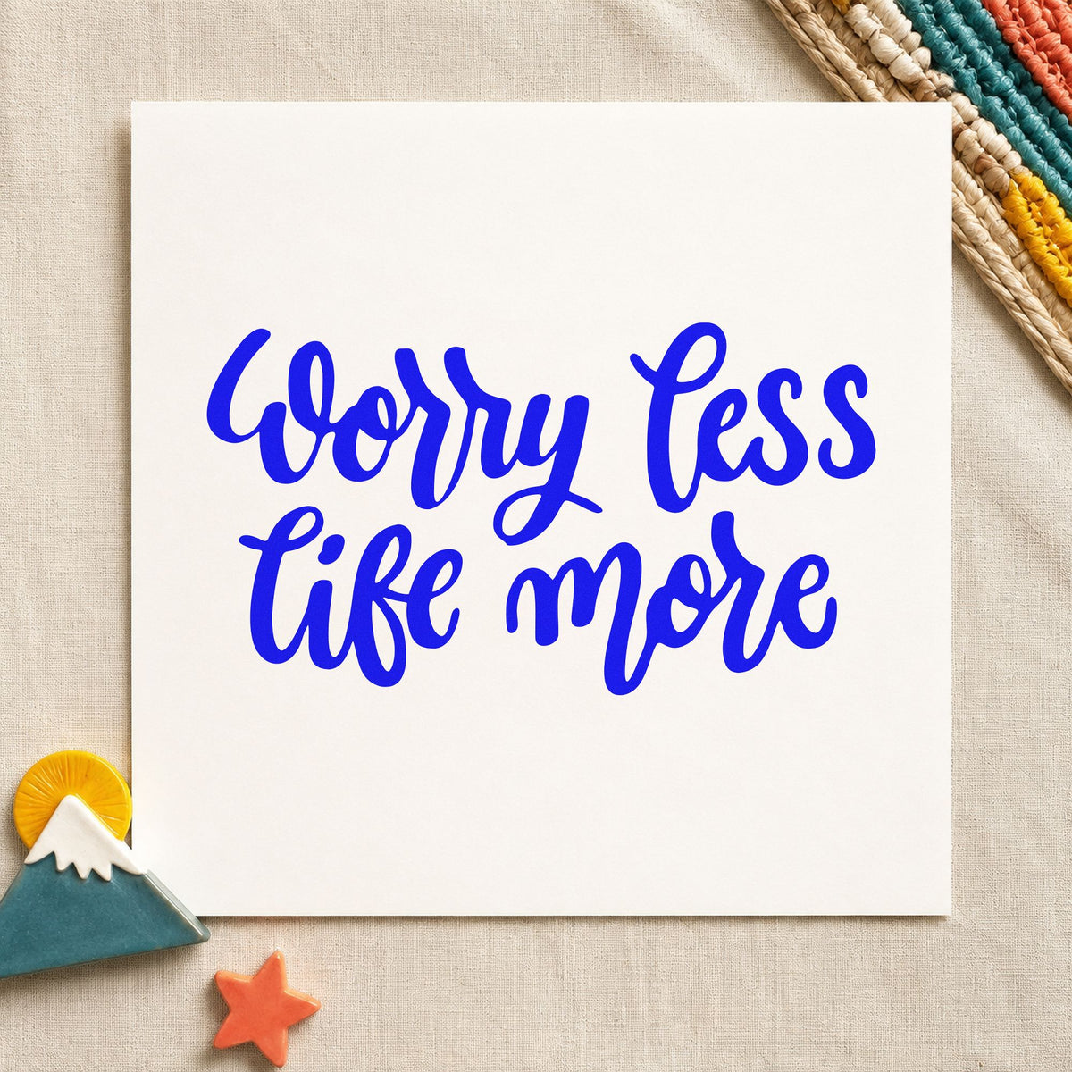 Worry Less Live More craft stamp imprinted in blue ink on paper, a design suited to framed porch beam.