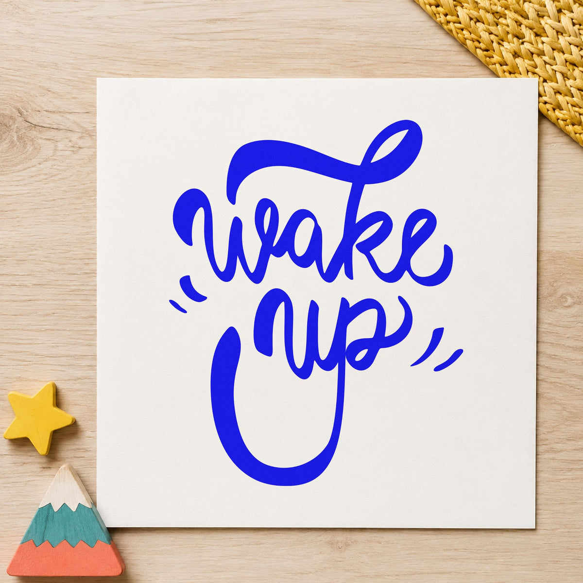 Wake Up Bold Script craft stamp in blue ink on cardstock, an easy option for baker apron printing.