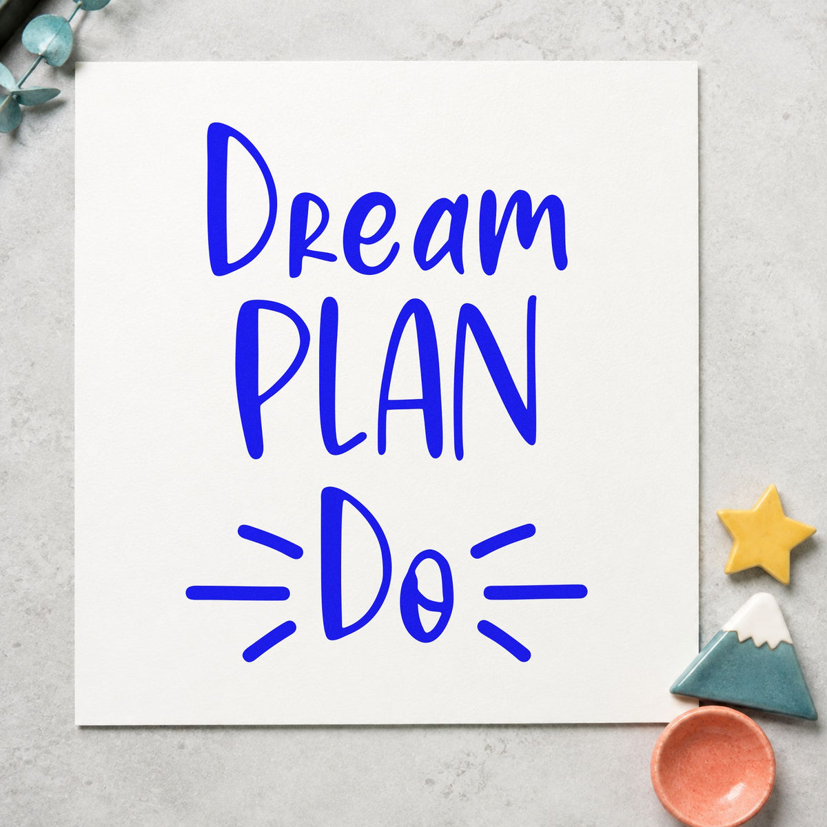 Dream Plan Do Lettering craft stamp in blue ink on cardstock, an easy option for drop cloth printing.