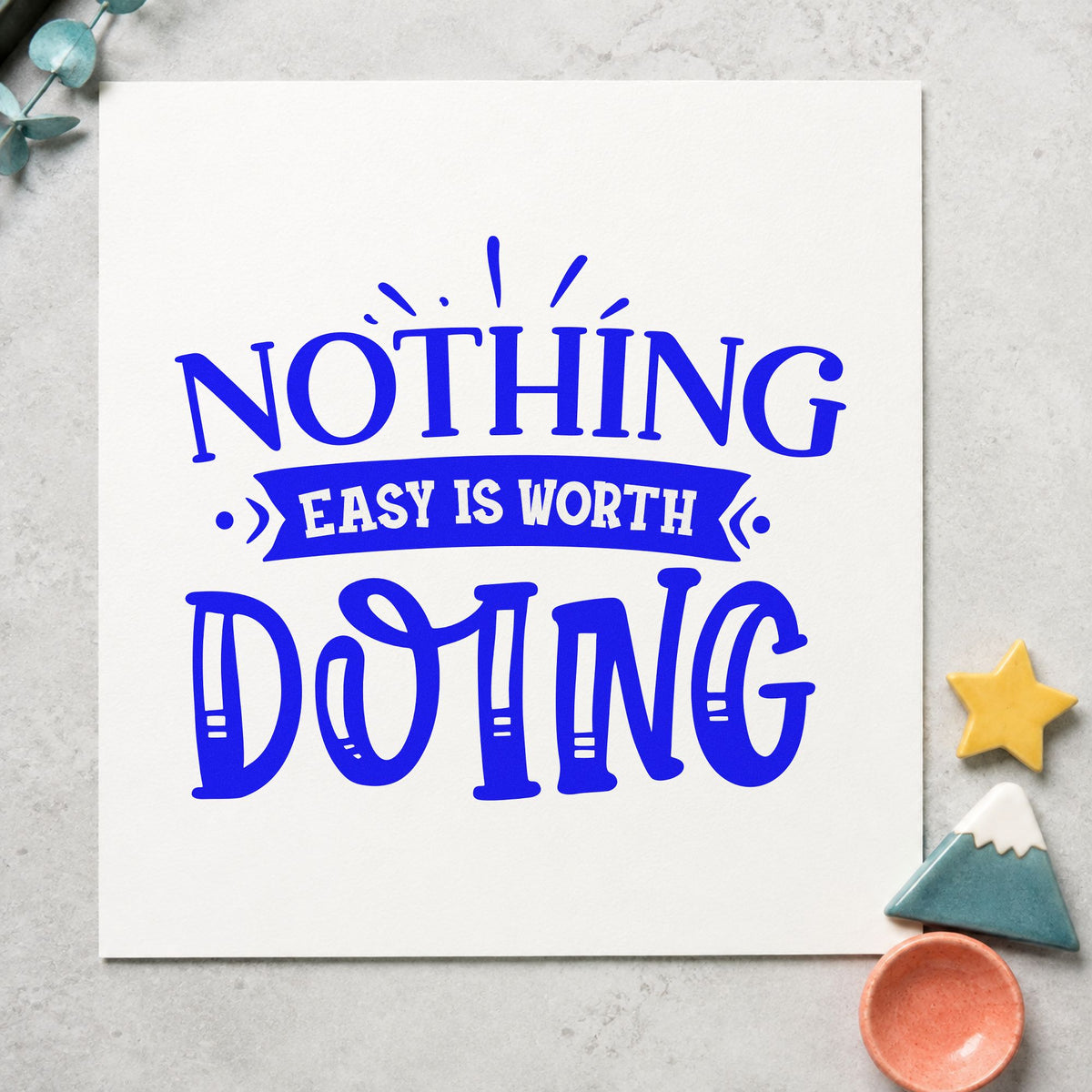 Nothing Easy Is Worth Doing craft stamp imprinted in blue ink on paper, a design suited to framed trail map.
