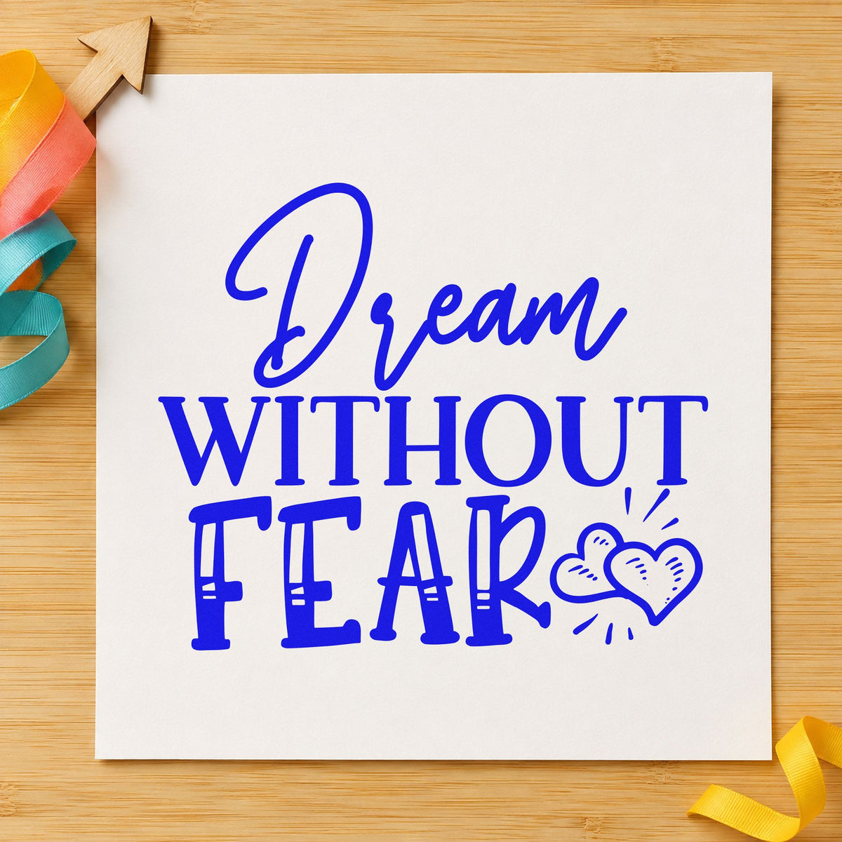 Dream Without Fear Hearts craft stamp in blue ink on cardstock, an easy option for jumpsuit patch printing.