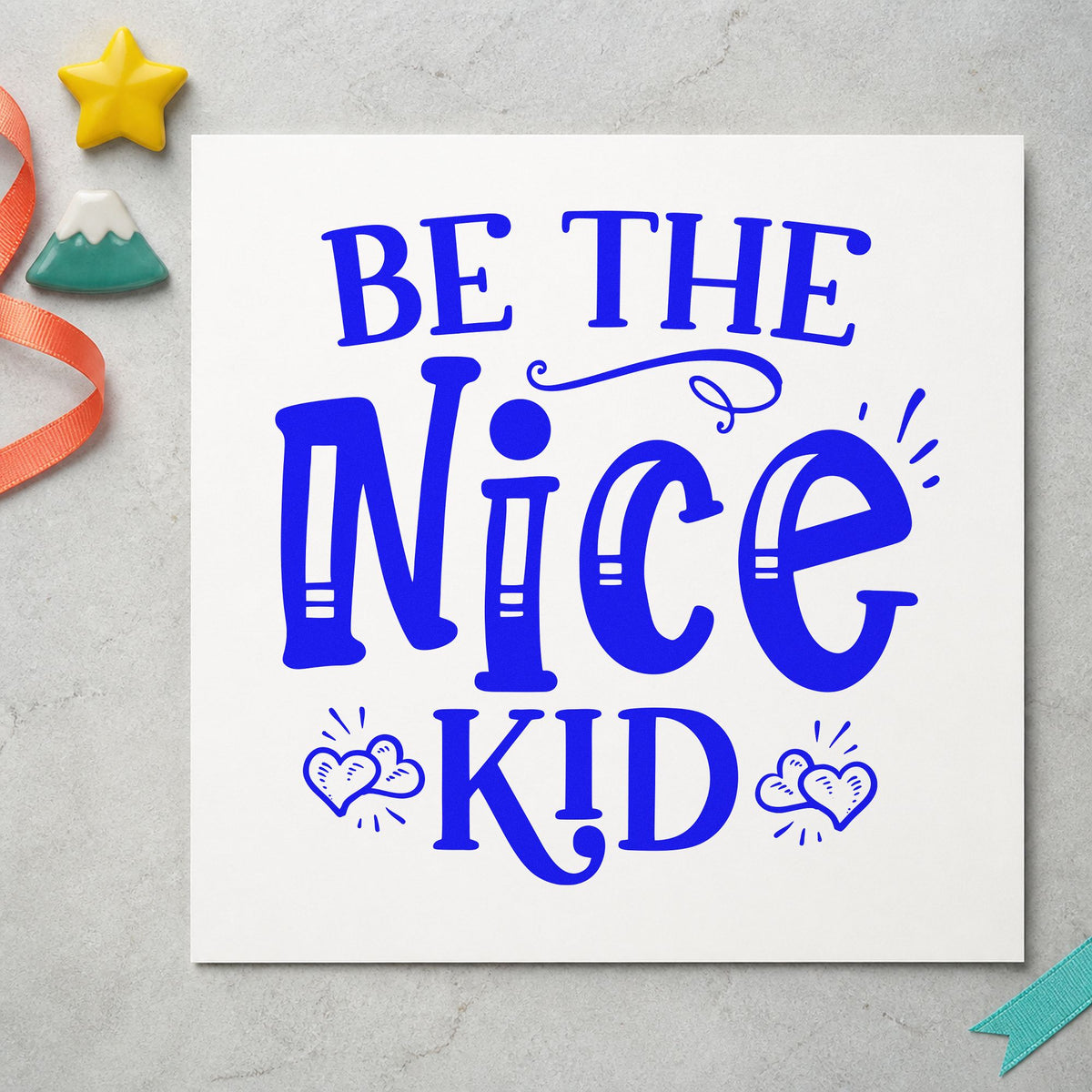 Be The Nice Kid craft stamp in blue ink on cardstock, an easy option for camp flag printing.