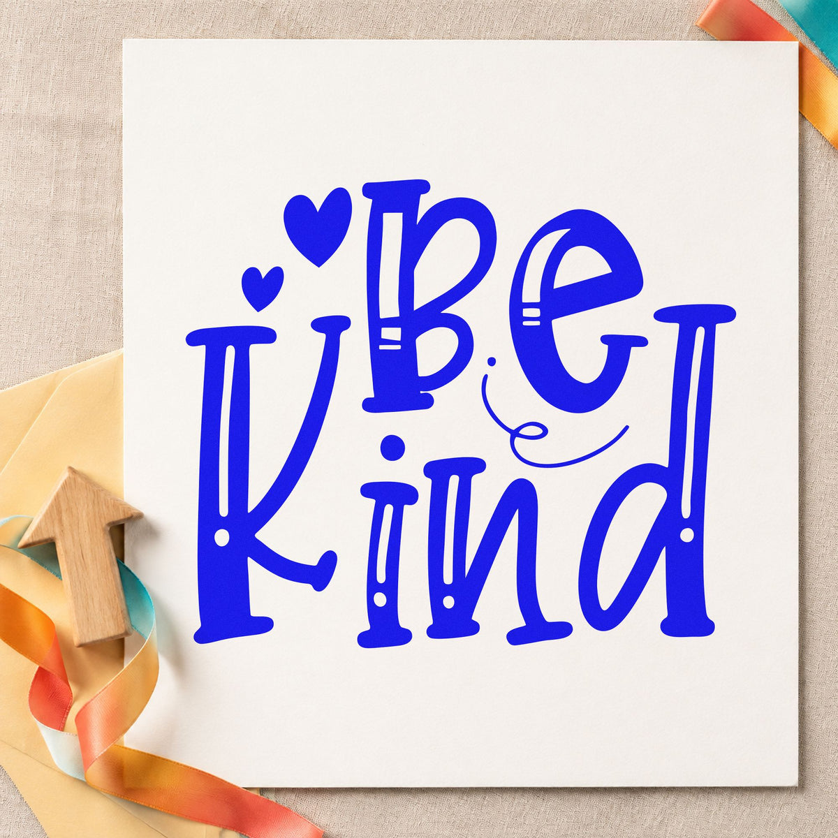 Be Kind Decorative Hearts craft stamp imprinted in blue ink on paper, a design suited to framed lobby wall.