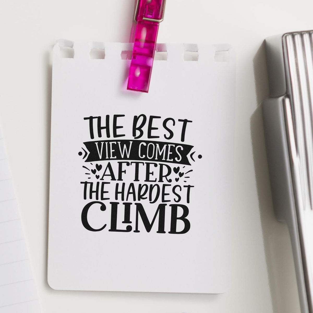 Best View After Hardest Climb Stamp - Premium Vintage Pro Wooden imprint stamped in black ink. The phrase "The best view comes after the hardest climb" includes a ribbon banner, hearts, and decorative rays.