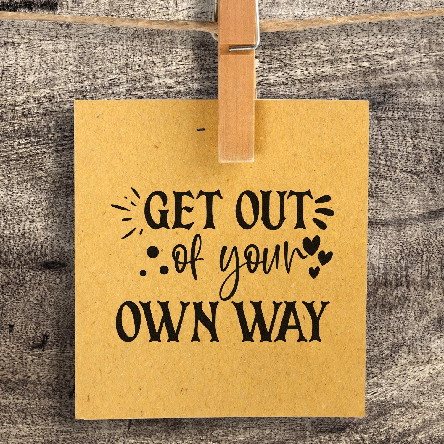 Inspirational rubber stamp quote, Get Out of Your Own Way, stamped on a kraft paper tag for motivational crafts.