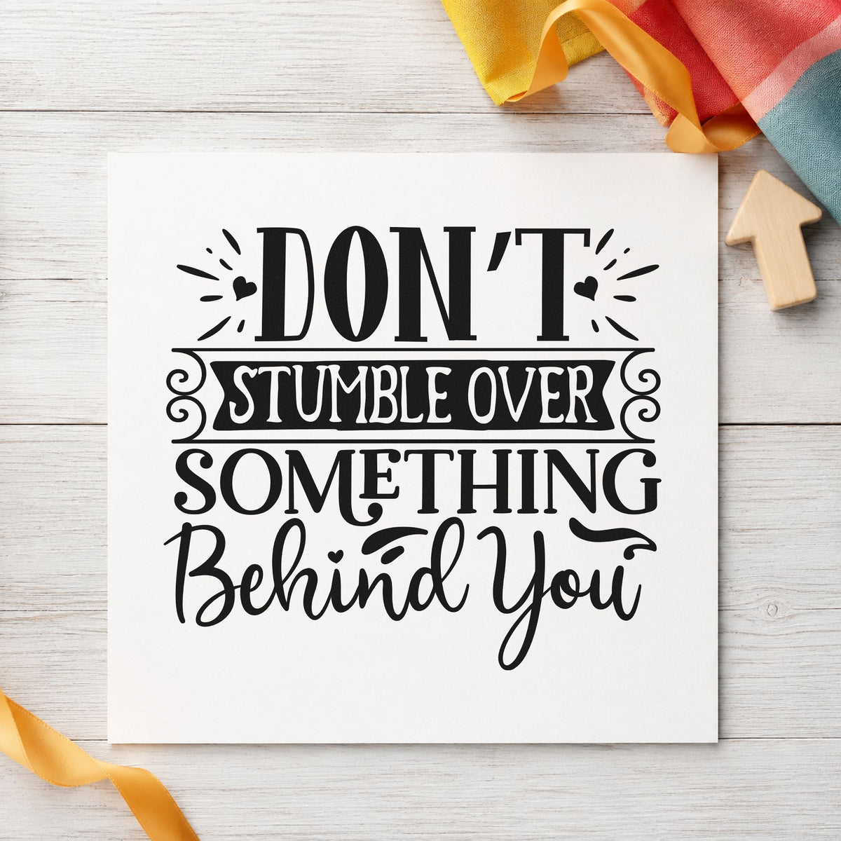 Don't Stumble Over Behind You craft stamp imprint in black ink on a handmade project, one idea being moving box gift tags.