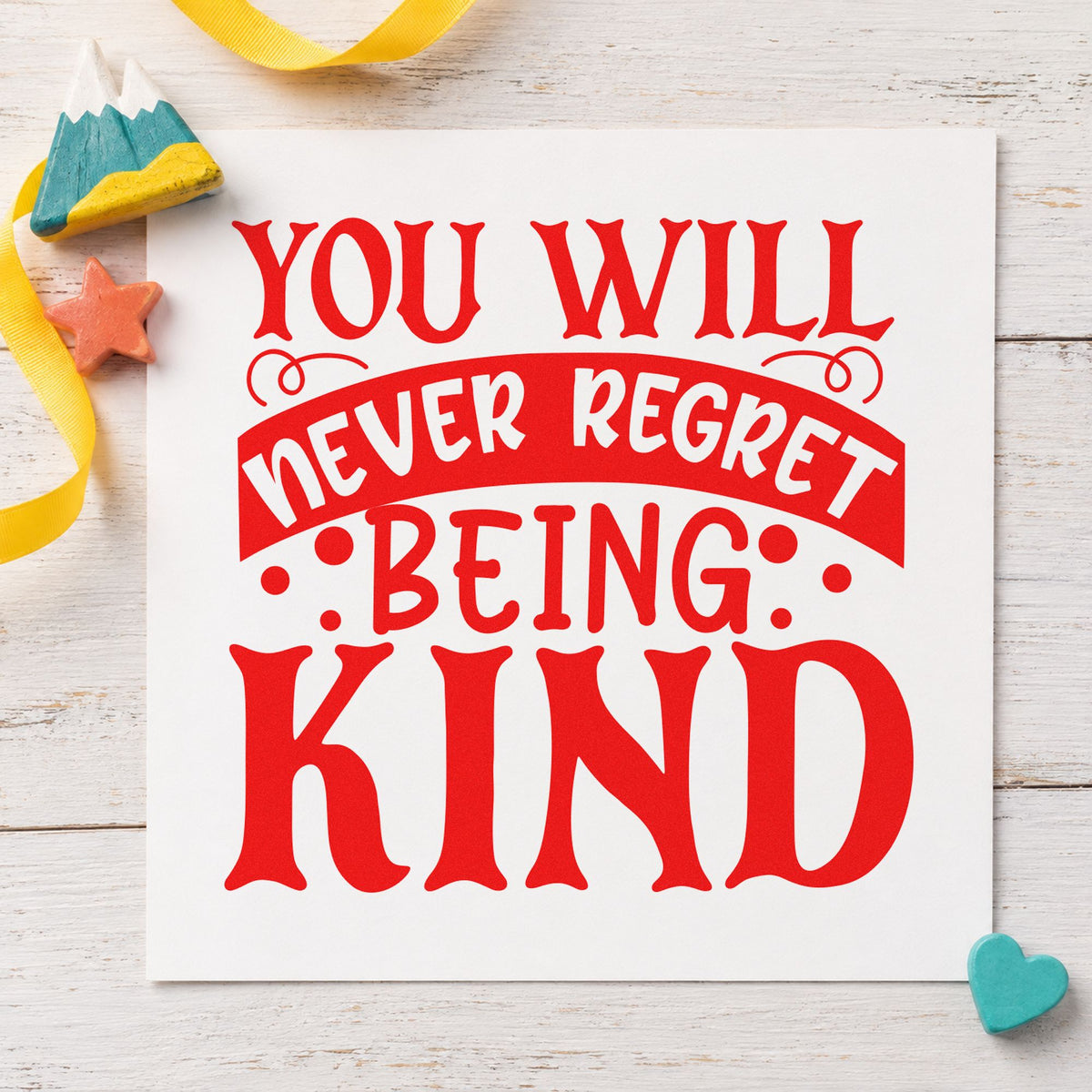 Never Regret Being Kind rubber stamp shown in red ink, stamped for projects such as bin syrup labels.