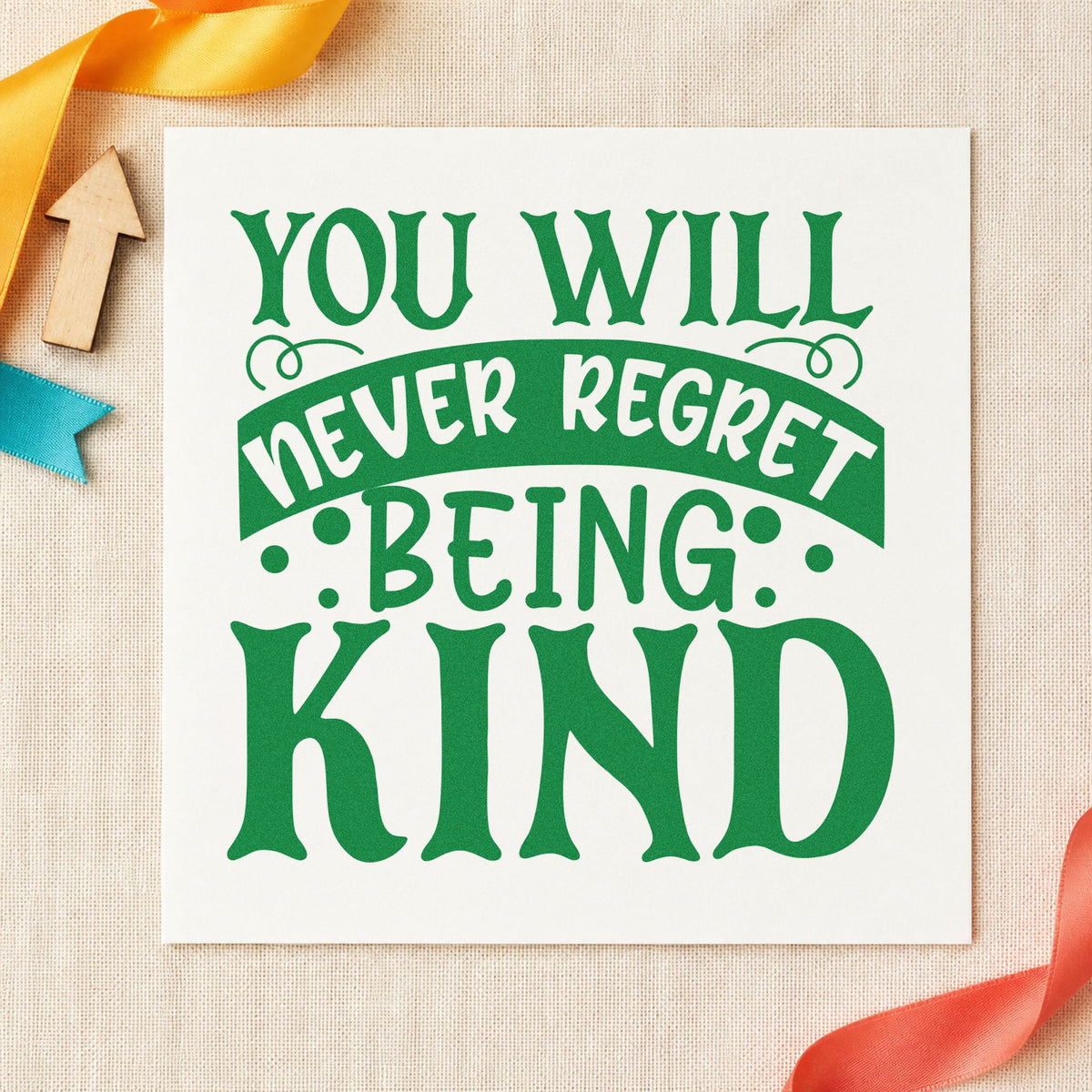 Never Regret Being Kind craft stamp imprint in green ink on a handmade project, one idea being regular note cards.