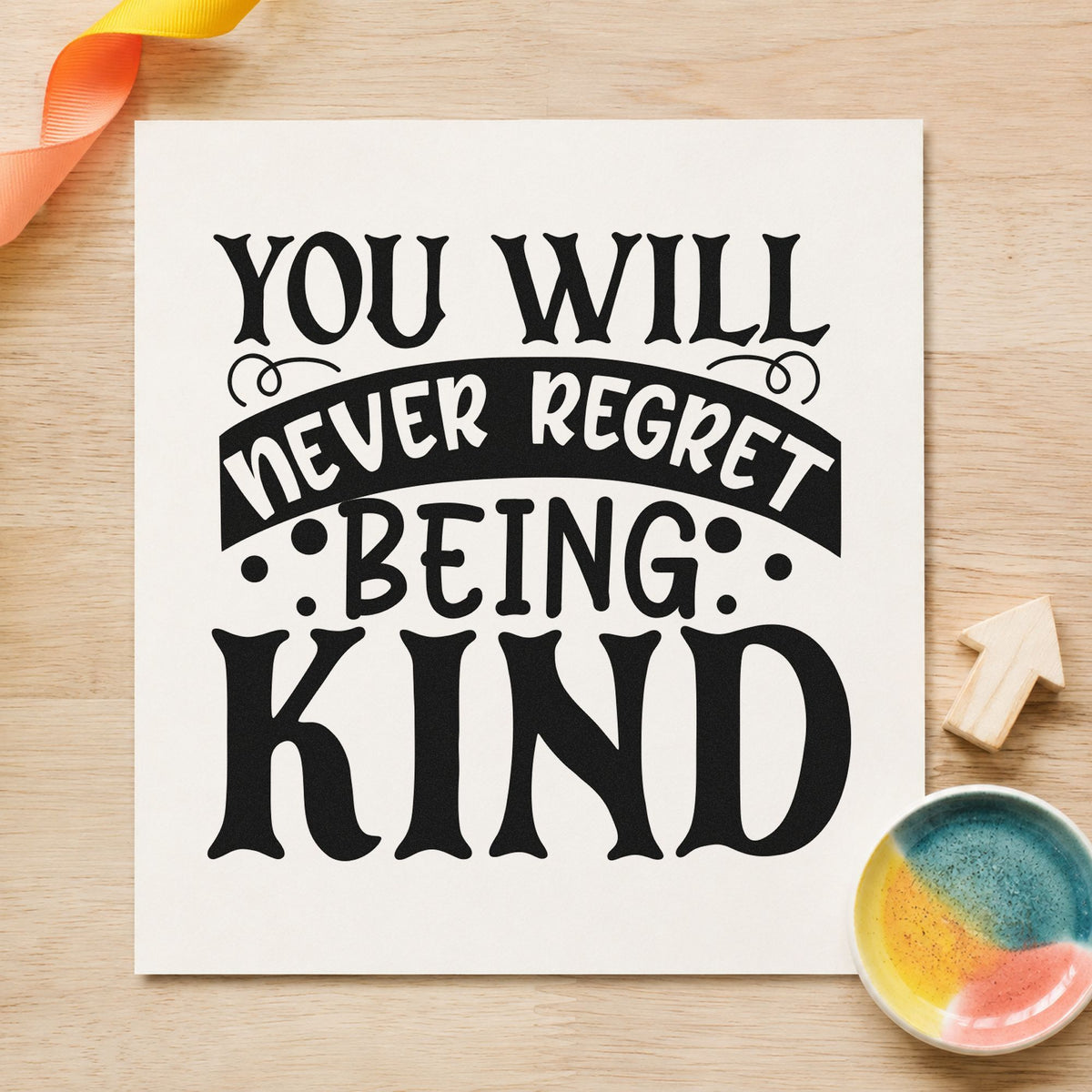 Never Regret Being Kind rubber stamp printed in black ink, ready for oversized capital cards and similar paper crafts.
