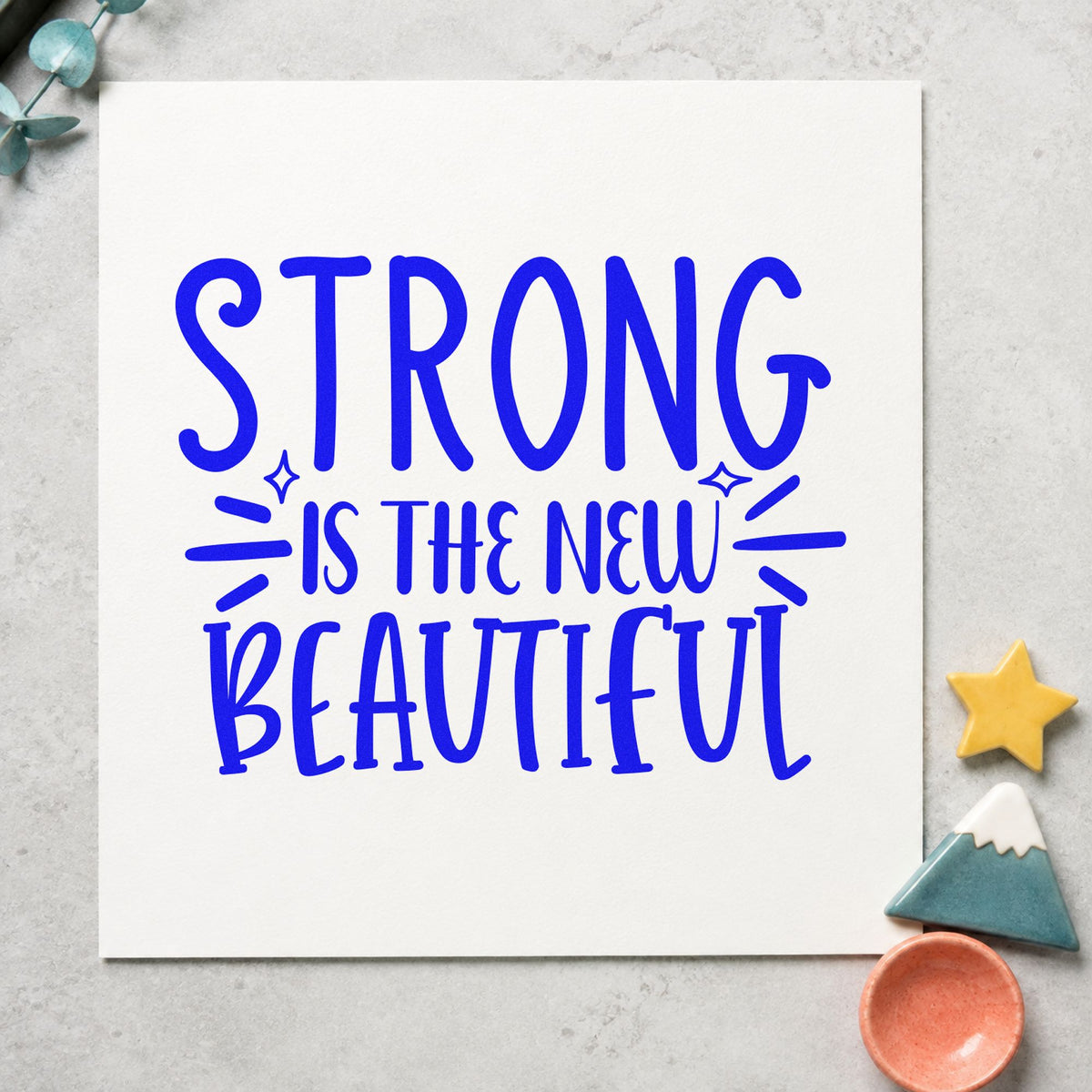 Strong New Beautiful Lettering craft stamp in blue ink on cardstock, an easy option for crew jacket printing.