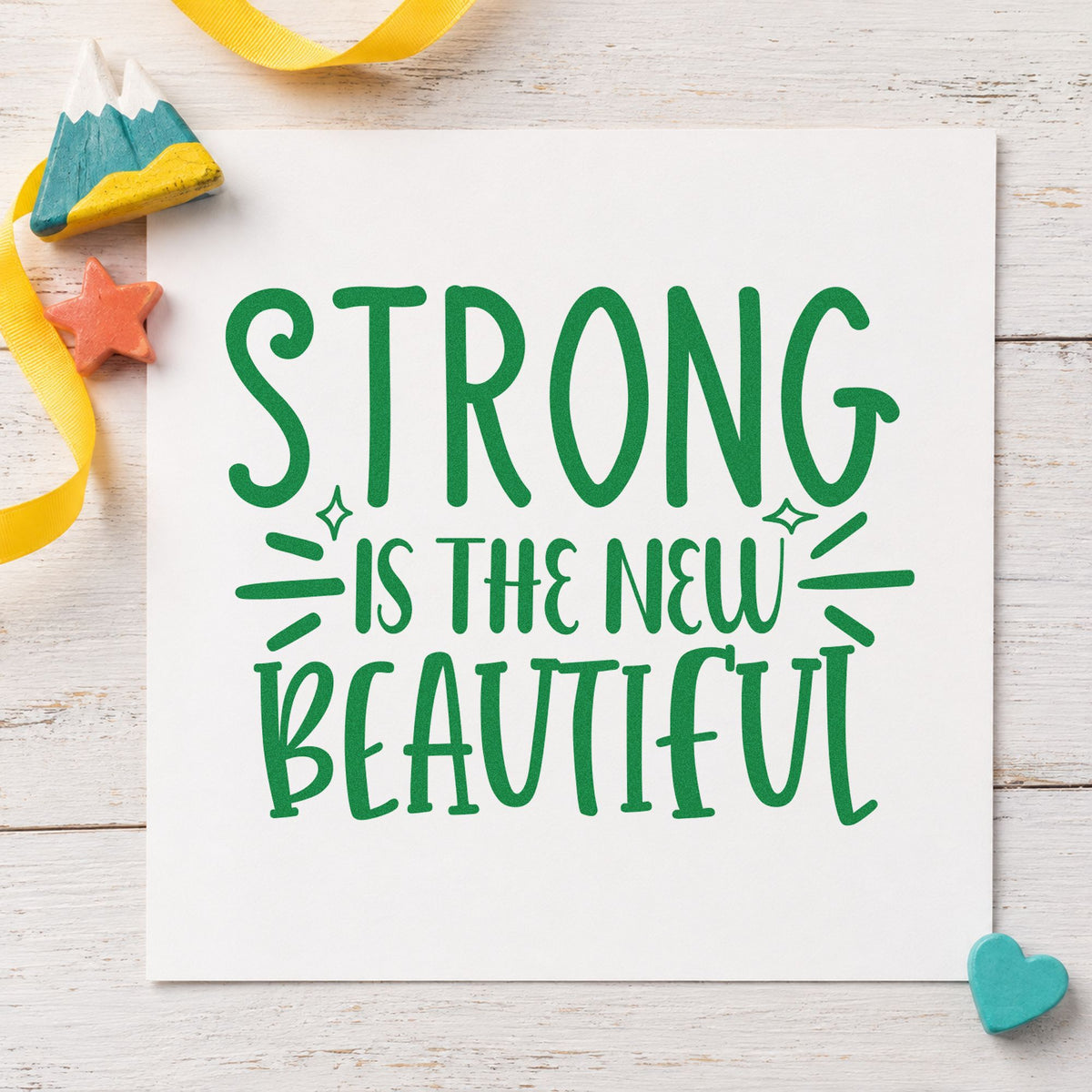 Strong New Beautiful Lettering craft stamp imprint in green ink on a handmade project, one idea being seat assign cards.