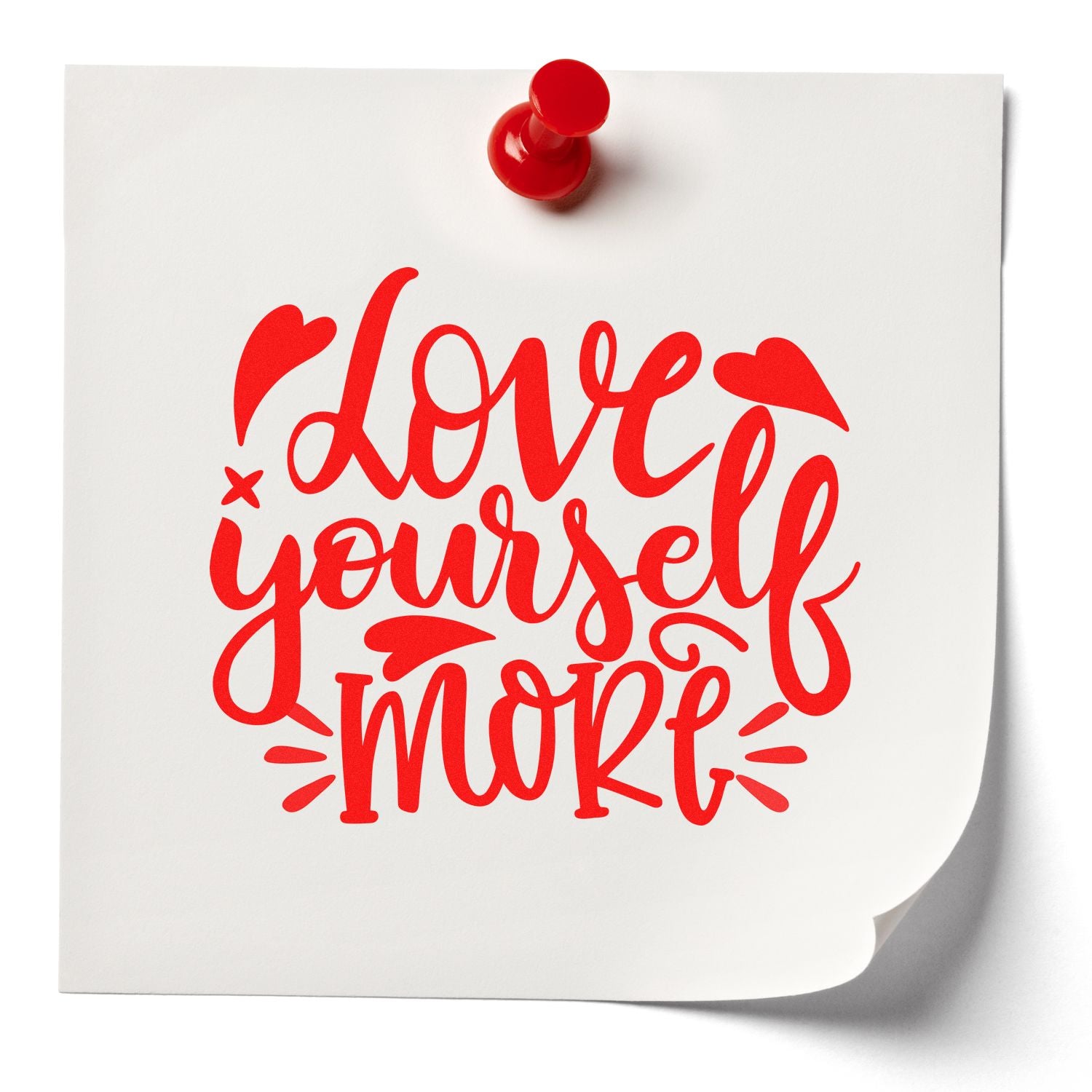 Love Yourself More rubber stamp design mockup on pinned paper, featuring bold red script for motivational crafts.