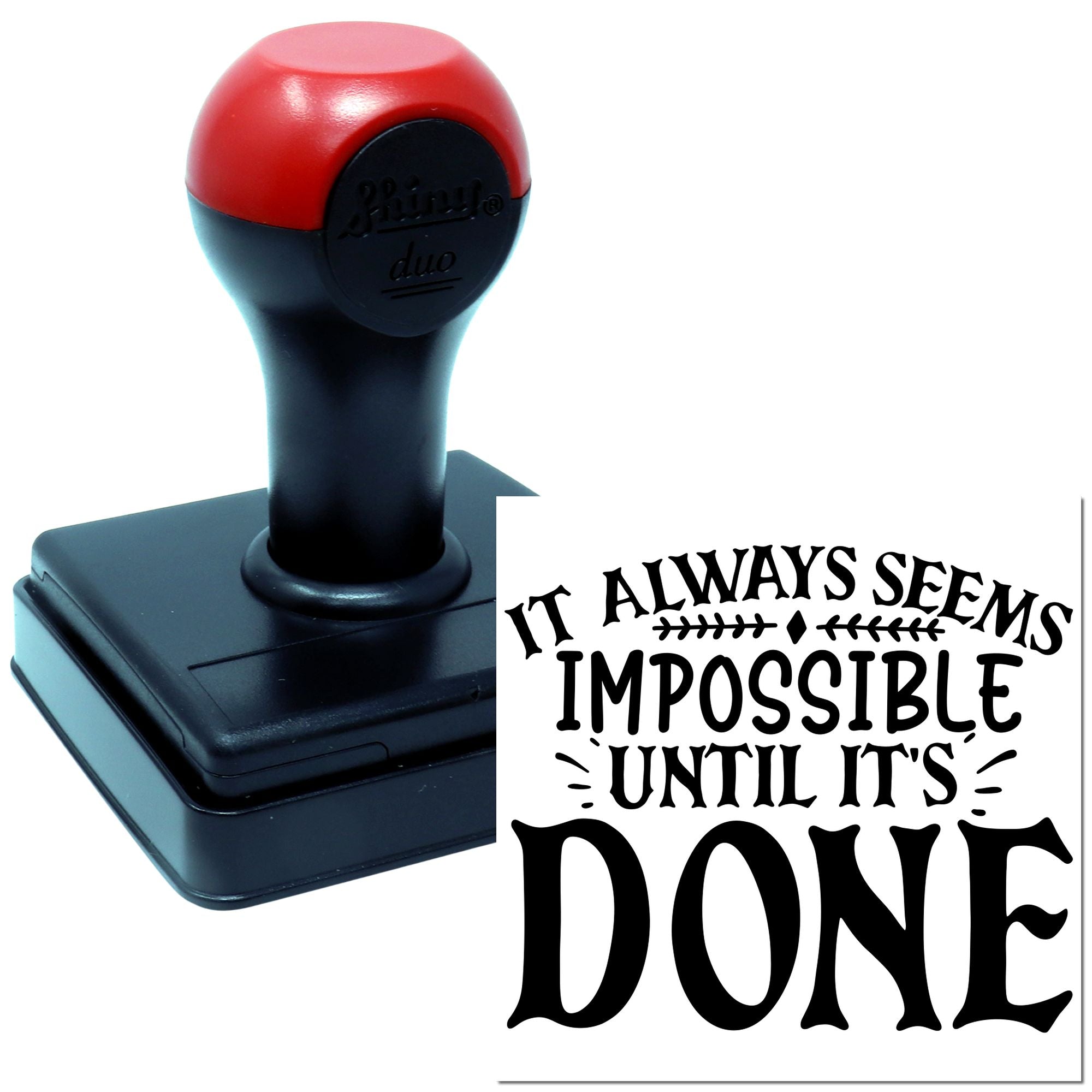 Self-inking rubber stamp with inspirational quote impression, "It always seems impossible until it's done," for office or craft use.