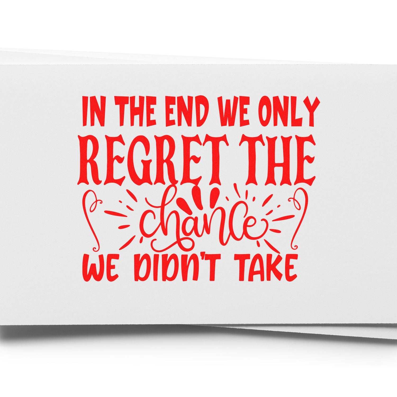 Motivational rubber stamp design with quote, In the end we only regret the chance we didnt take, in bold red lettering.