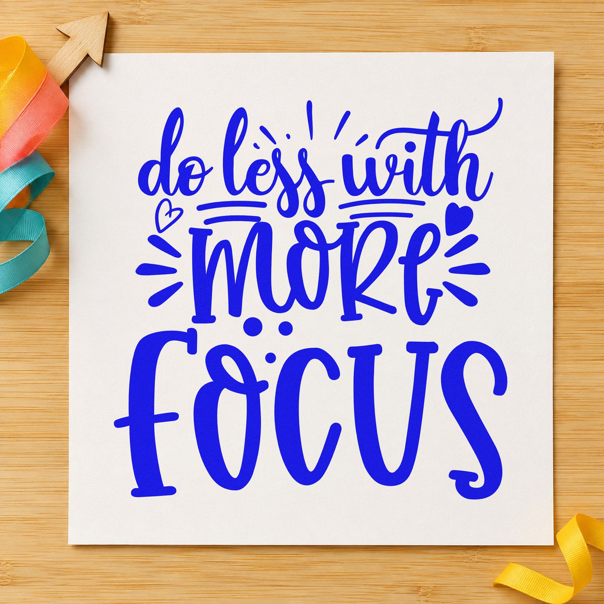 Do Less With More Focus craft stamp imprinted in blue ink on paper, a design suited to framed office shelf.
