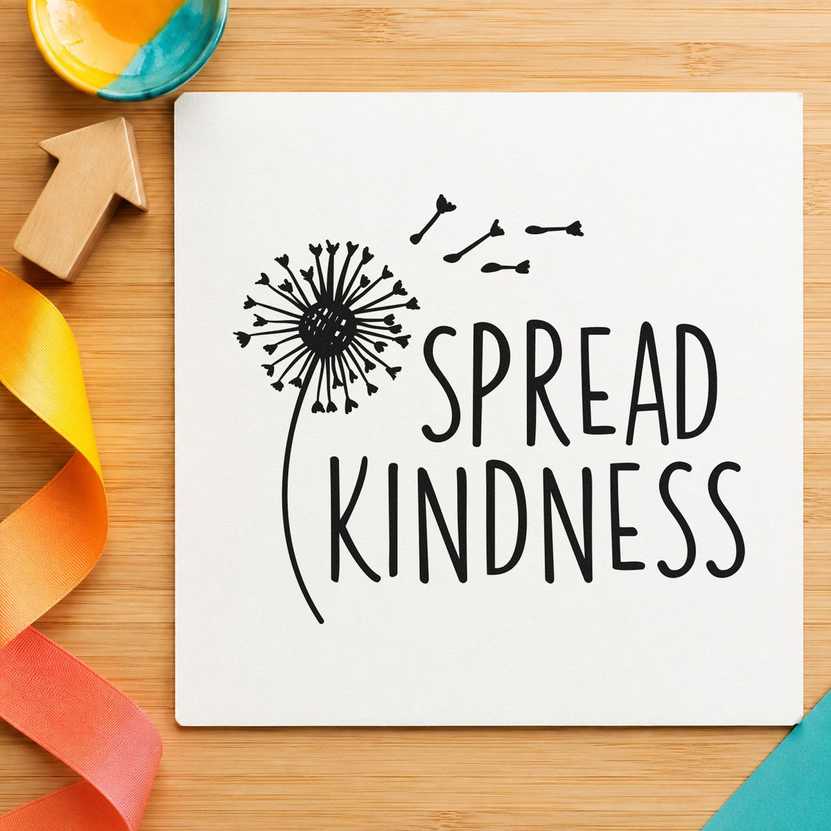 Spread Kindness Dandelion Seeds craft stamp imprint in black ink on a handmade project, one idea being wildflower gift tags.