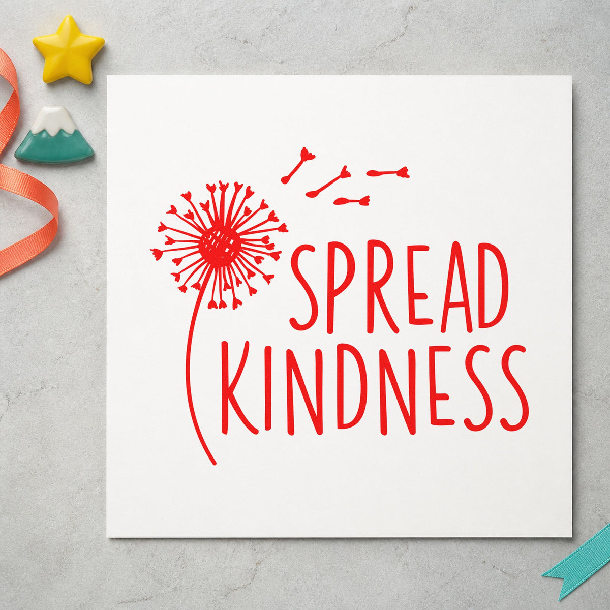 Spread Kindness Dandelion Seeds rubber stamp shown in red ink, stamped for projects such as bed species labels.