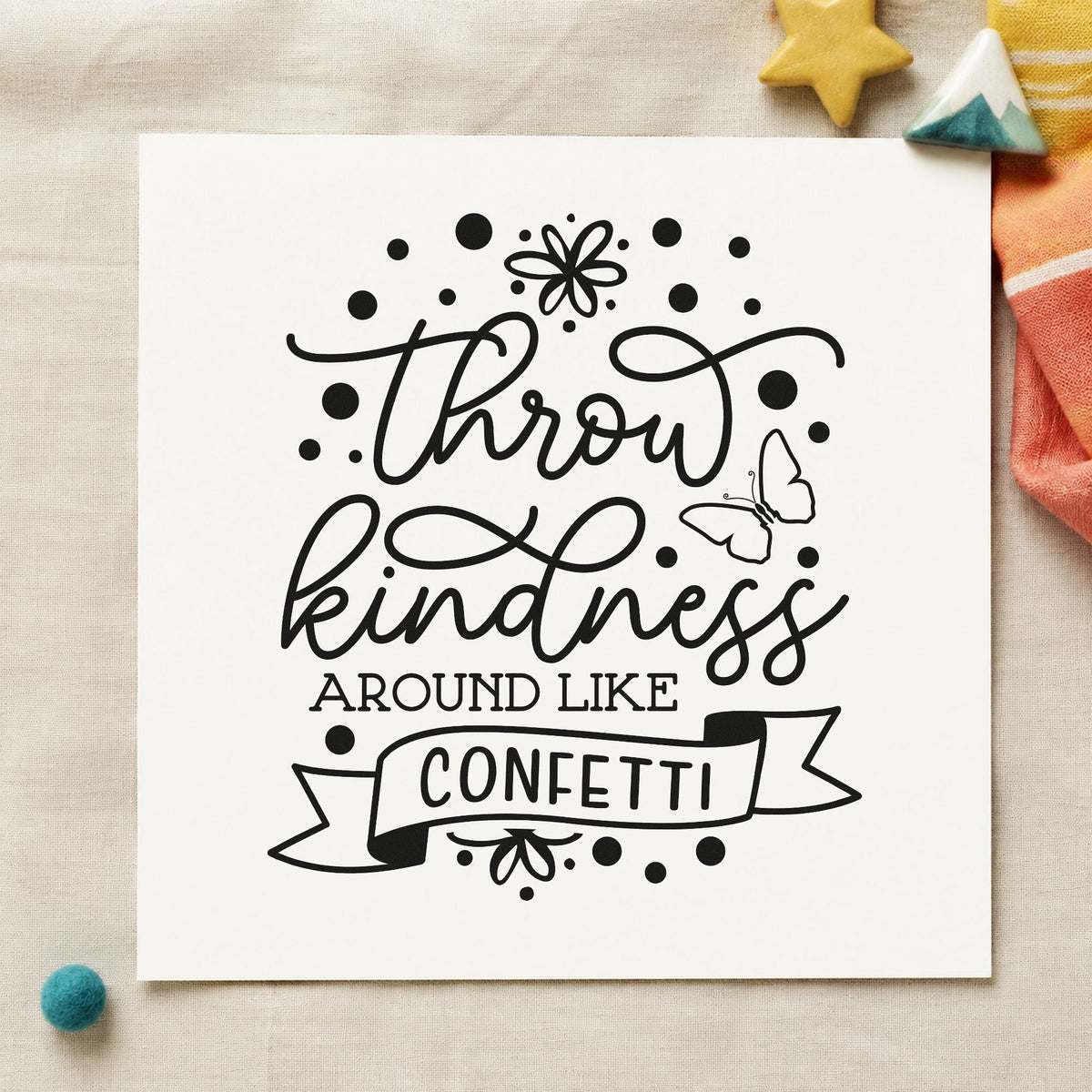 Throw Kindness Like Confetti craft stamp imprint in black ink on a handmade project, one idea being paint kit gift tags.
