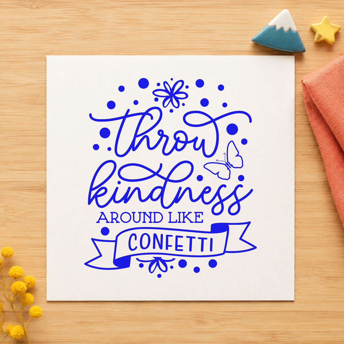 Throw Kindness Like Confetti craft stamp in blue ink on cardstock, an easy option for drop sheet printing.