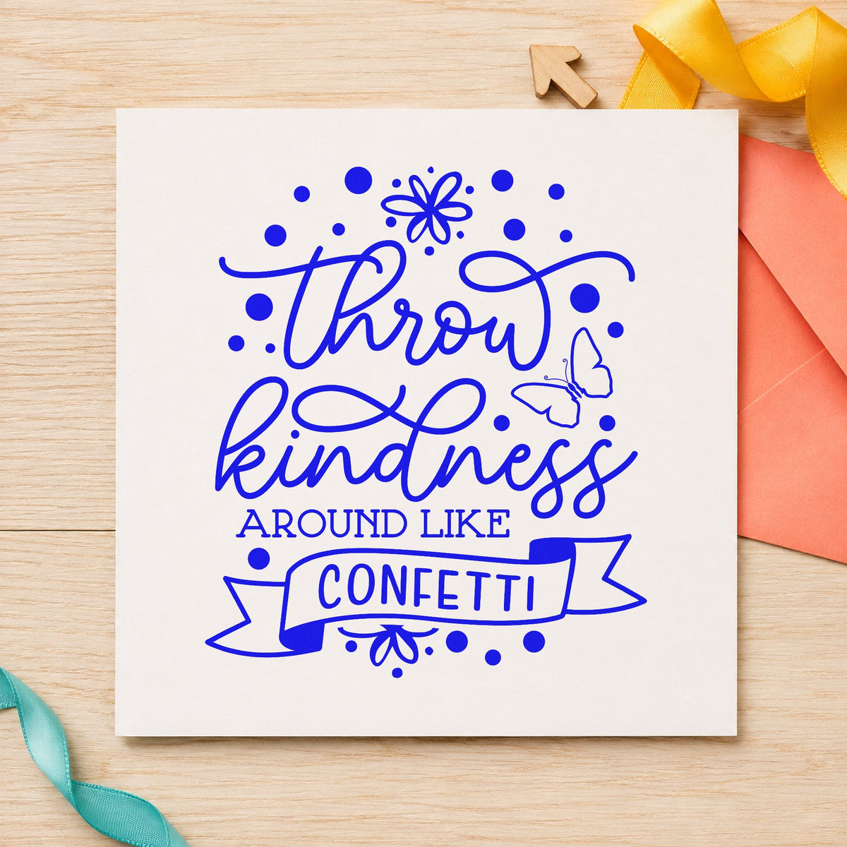 Throw Kindness Like Confetti craft stamp imprinted in blue ink on paper, a design suited to framed community center.