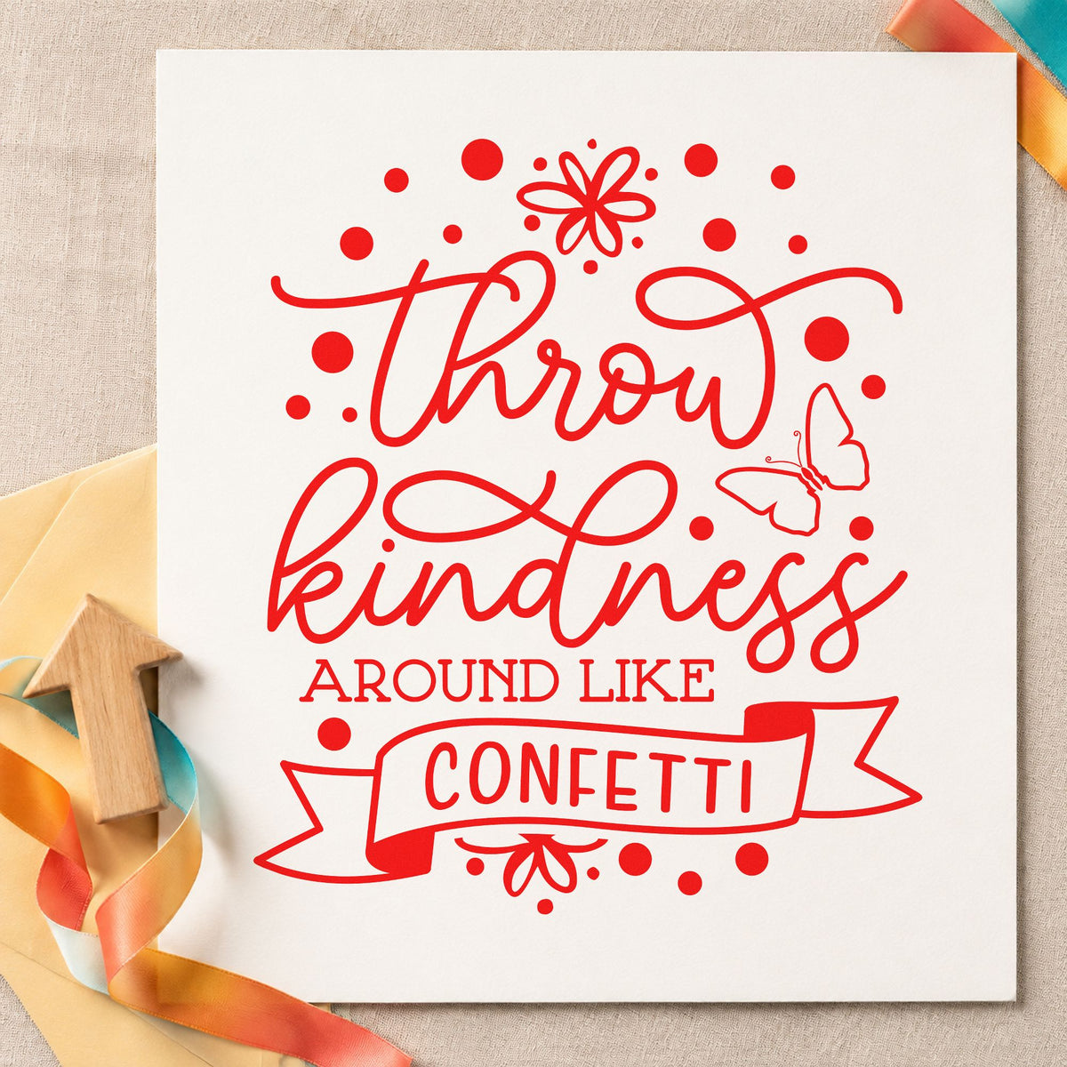 Throw Kindness Like Confetti craft stamp imprint in red ink on a handmade project, one idea being painter thanks cards.
