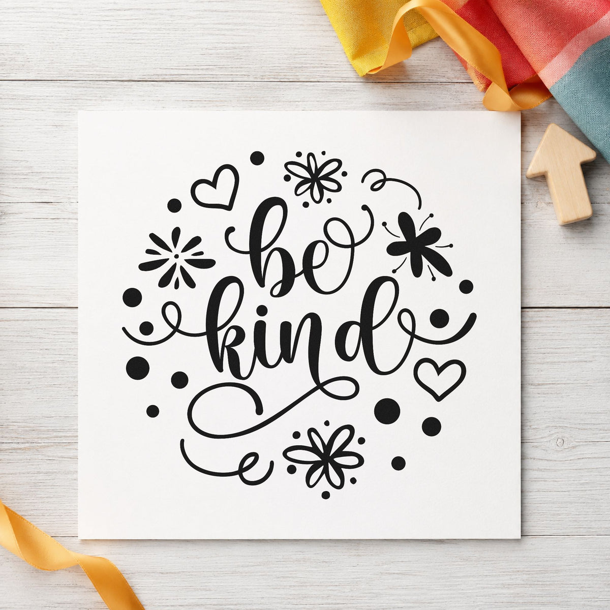 Be Kind Flowers Hearts craft stamp imprint in black ink on a handmade project, one idea being cutting gift tags.