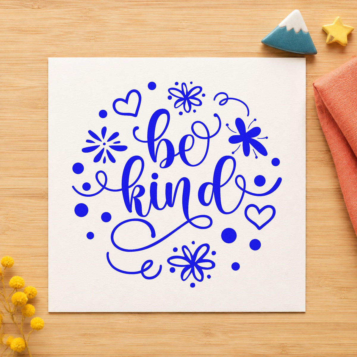 Be Kind Flowers Hearts craft stamp imprinted in blue ink on paper, a design suited to framed greenhouse post.