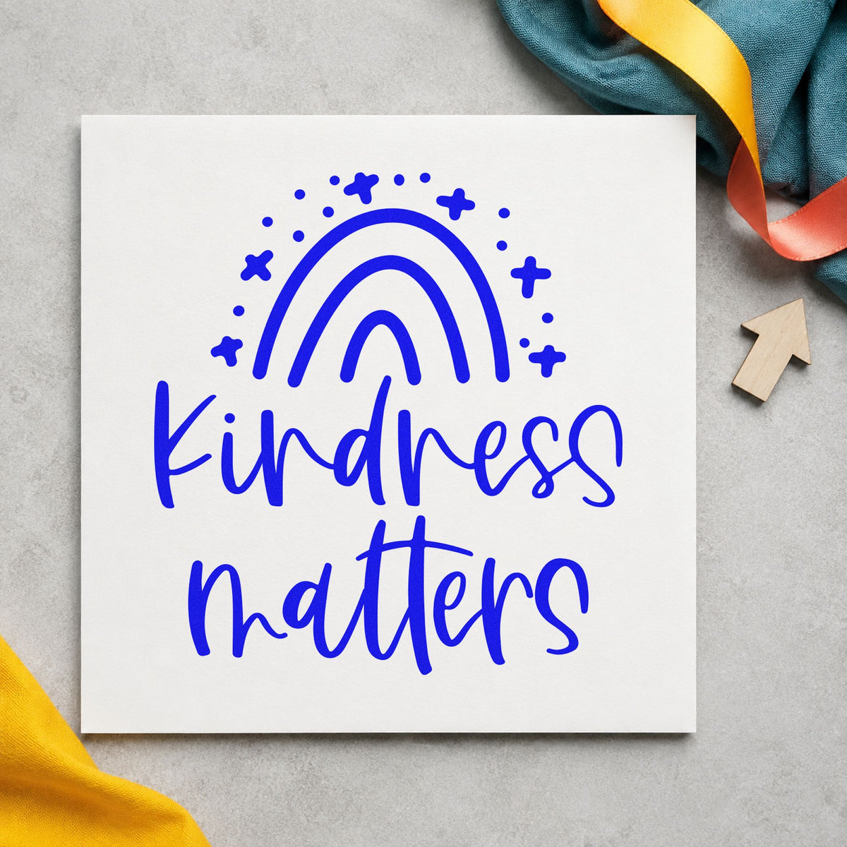 Kindness Matters Starry Rainbow craft stamp imprinted in blue ink on paper, a design suited to framed club house.