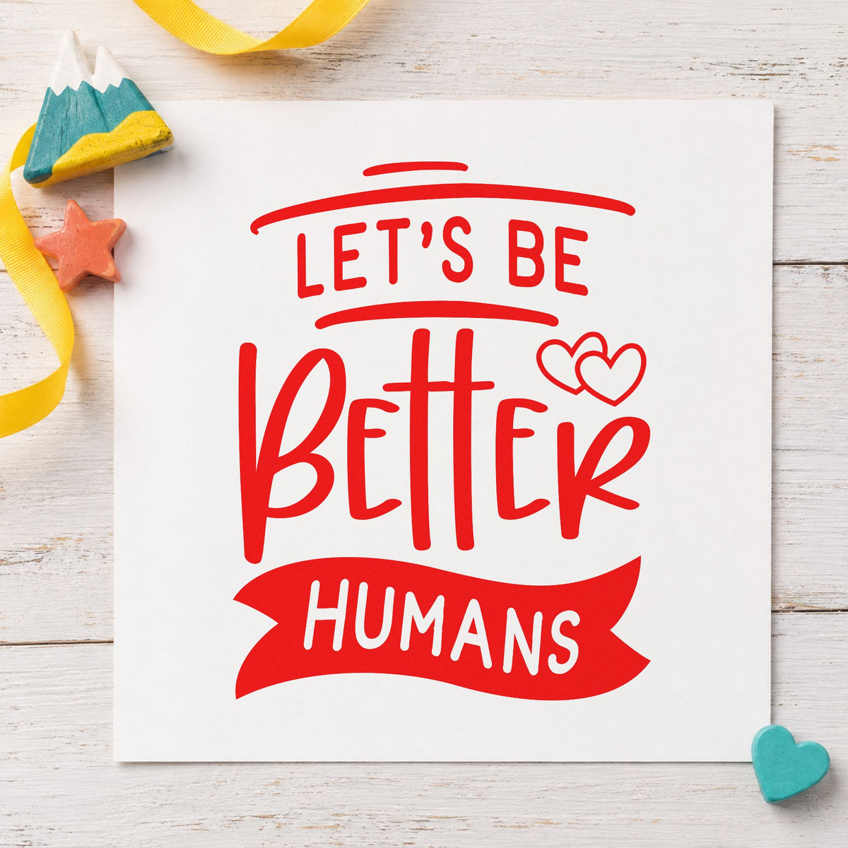 Let's Be Better Humans craft stamp imprint in red ink on a handmade project, one idea being peer thanks cards.