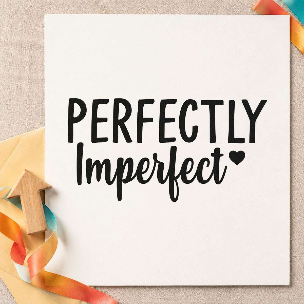Perfectly Imperfect Small Heart craft stamp imprint in black ink on a handmade project, one idea being skein gift tags.
