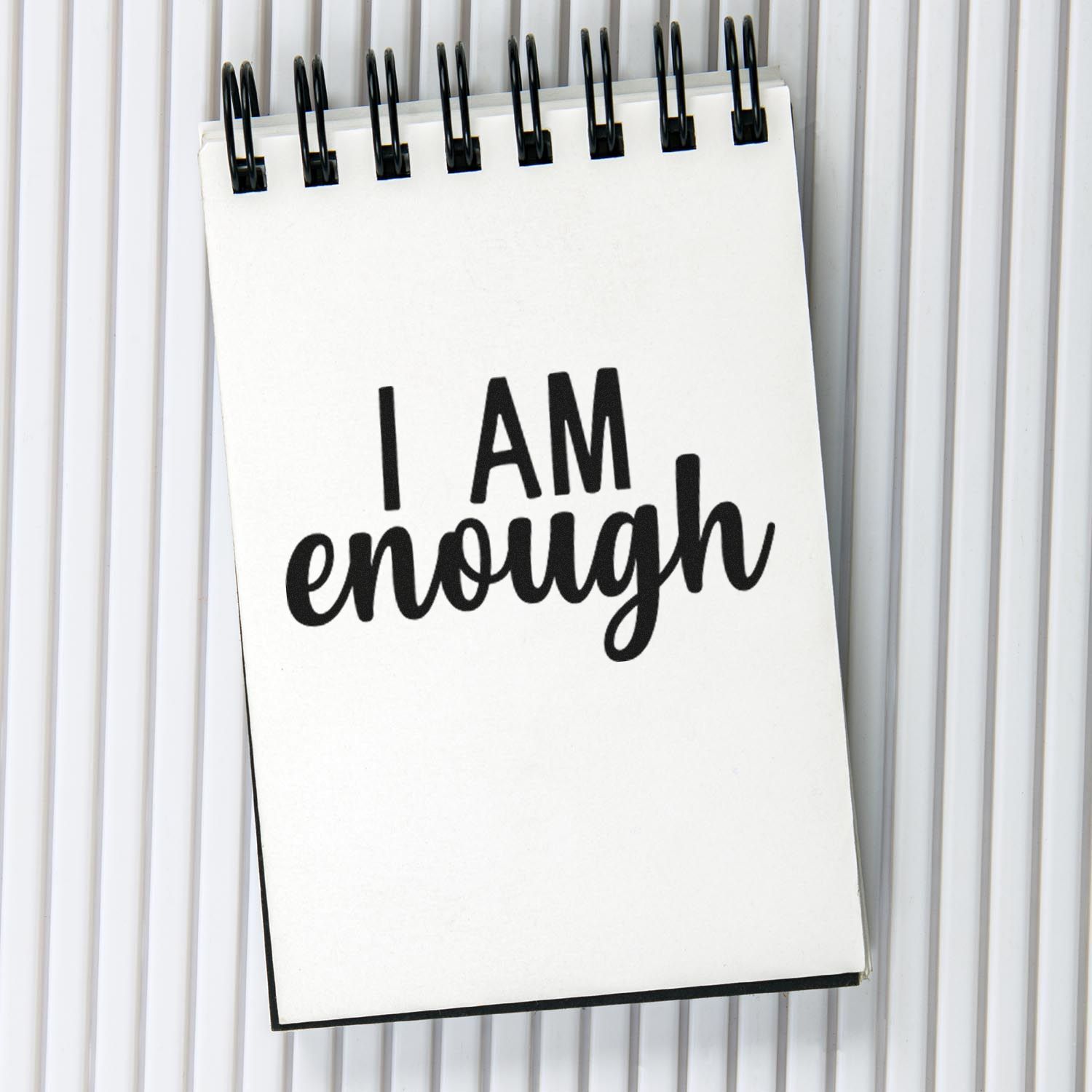 Motivational rubber stamp design reading I AM enough in bold black lettering for planners, journaling, and affirmations.