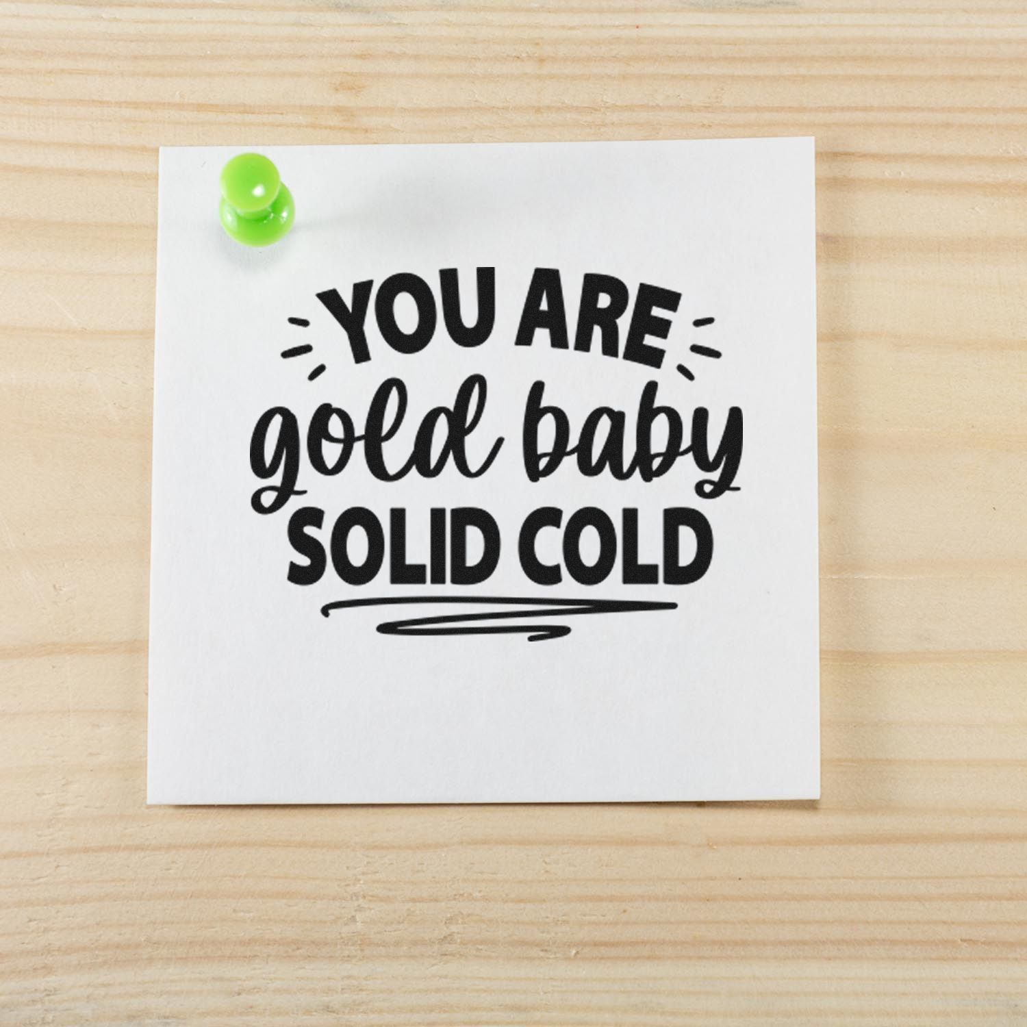 Humorous rubber stamp-style quote, You are gold baby solid cold, pinned on a note for crafts and stationery.