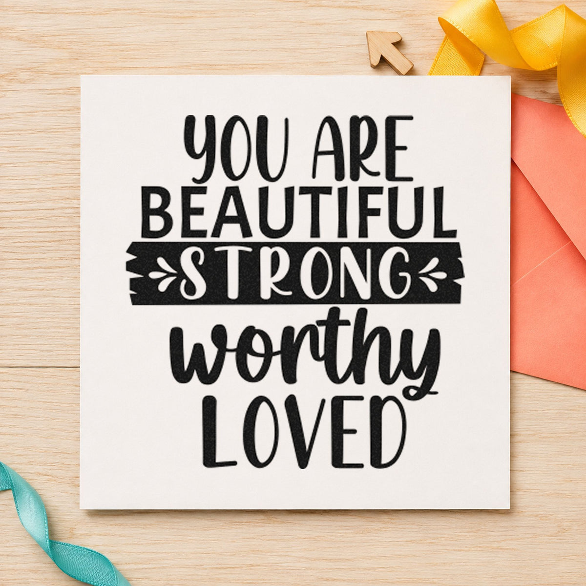 Beautiful Strong Worthy Loved craft stamp imprint in black ink on a handmade project, one idea being welcome bag gift tags.