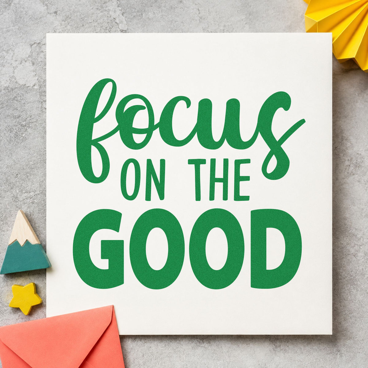 Focus On The Good craft stamp imprint in green ink on a handmade project, one idea being table question cards.