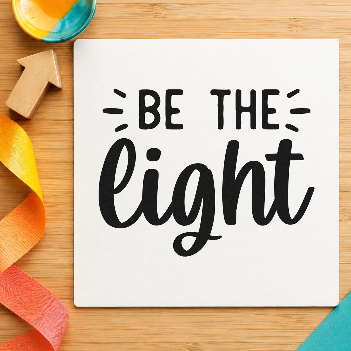 Be The Light Script craft stamp imprint in black ink on a handmade project, one idea being candle gift tags.